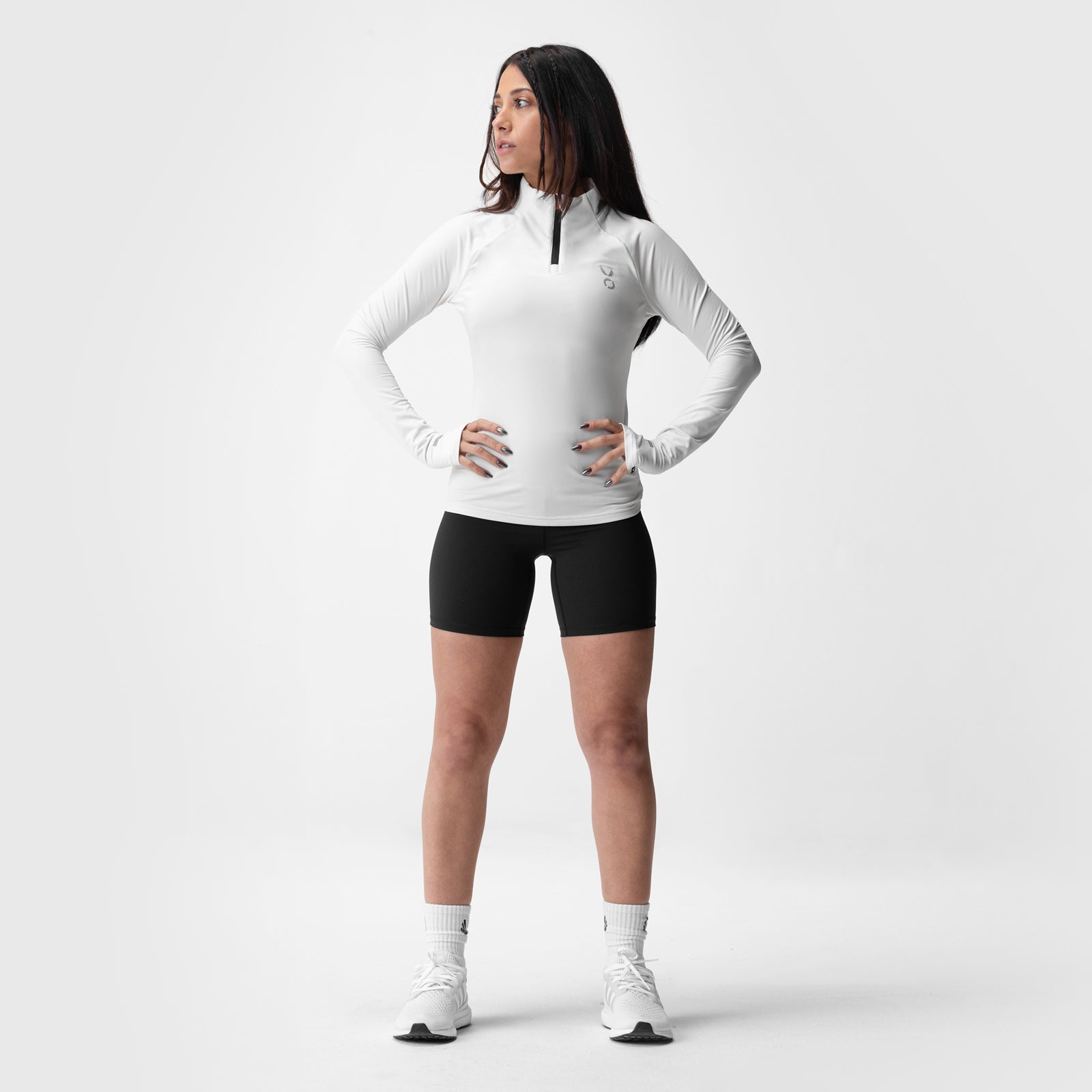 ASRV Performance Quarter Zip in ivory cream worn with black shorts, front view