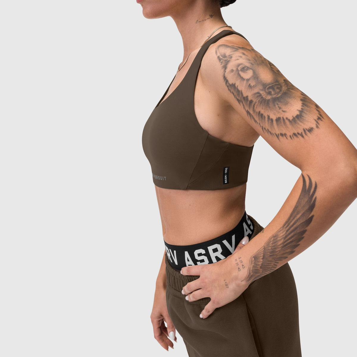 W039 Lycra Hybrid Sports Bra in dark earth, worn by model in side profile pose