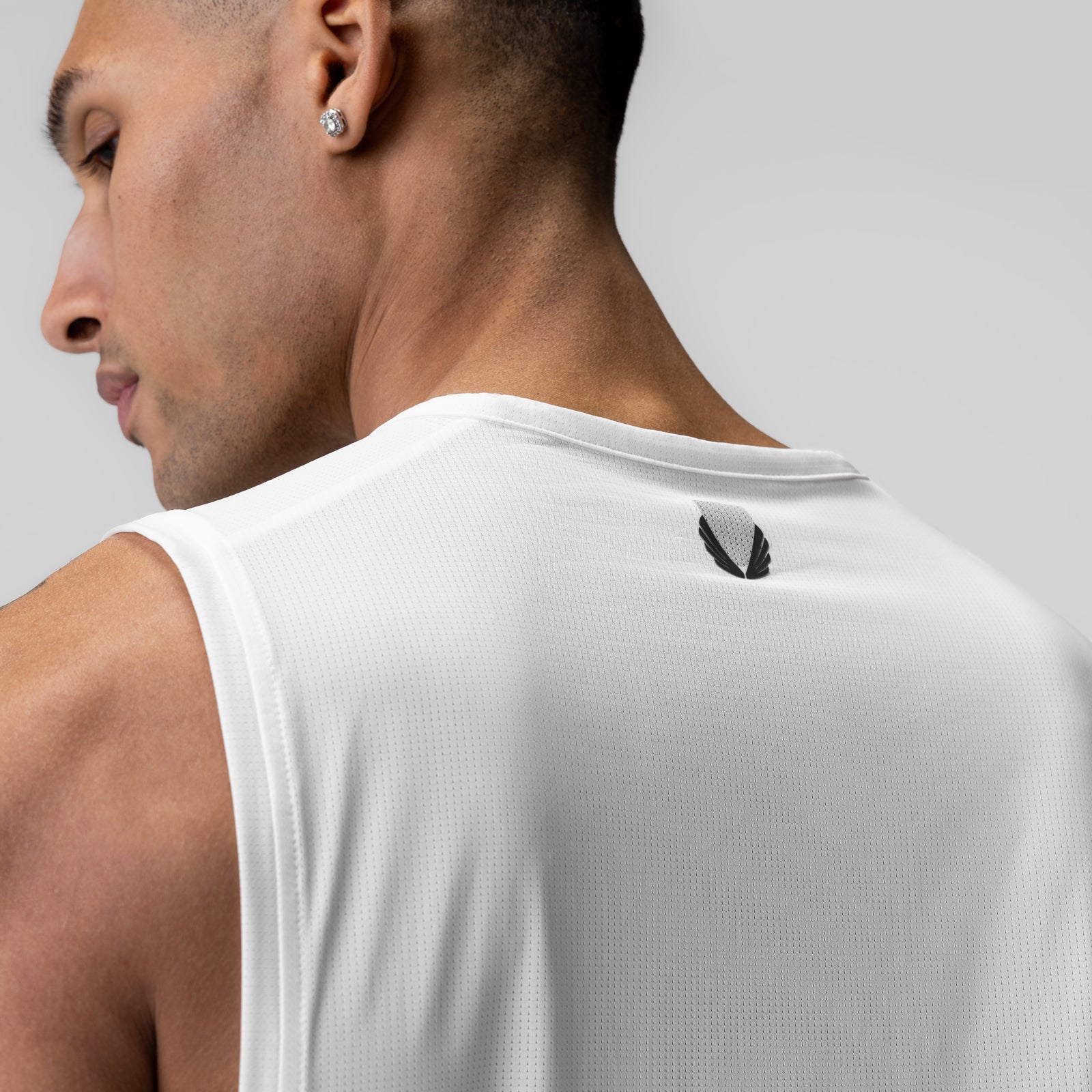 Ice-Skin™ Muscle Tank in white, worn by model shown from behind