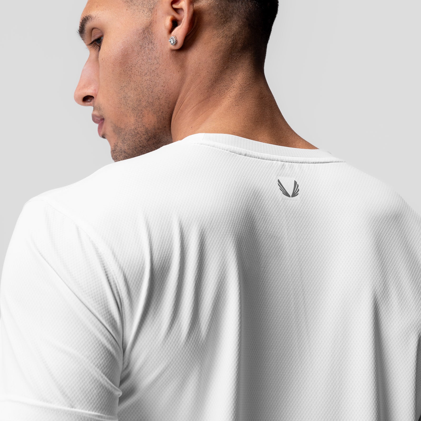 AeroSilver Essential Tee in white, back view on model