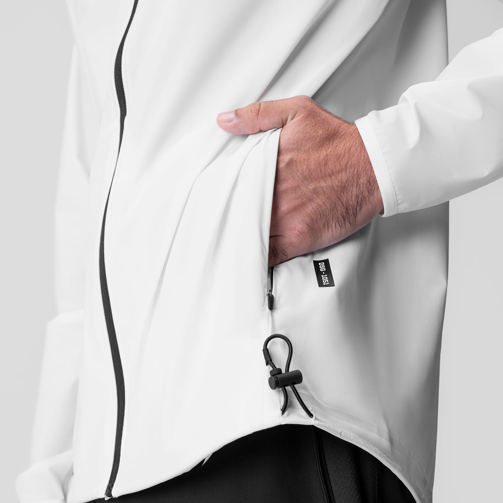 Aerotex™ Lightweight Windbreaker in white, worn by model showing side pocket detail