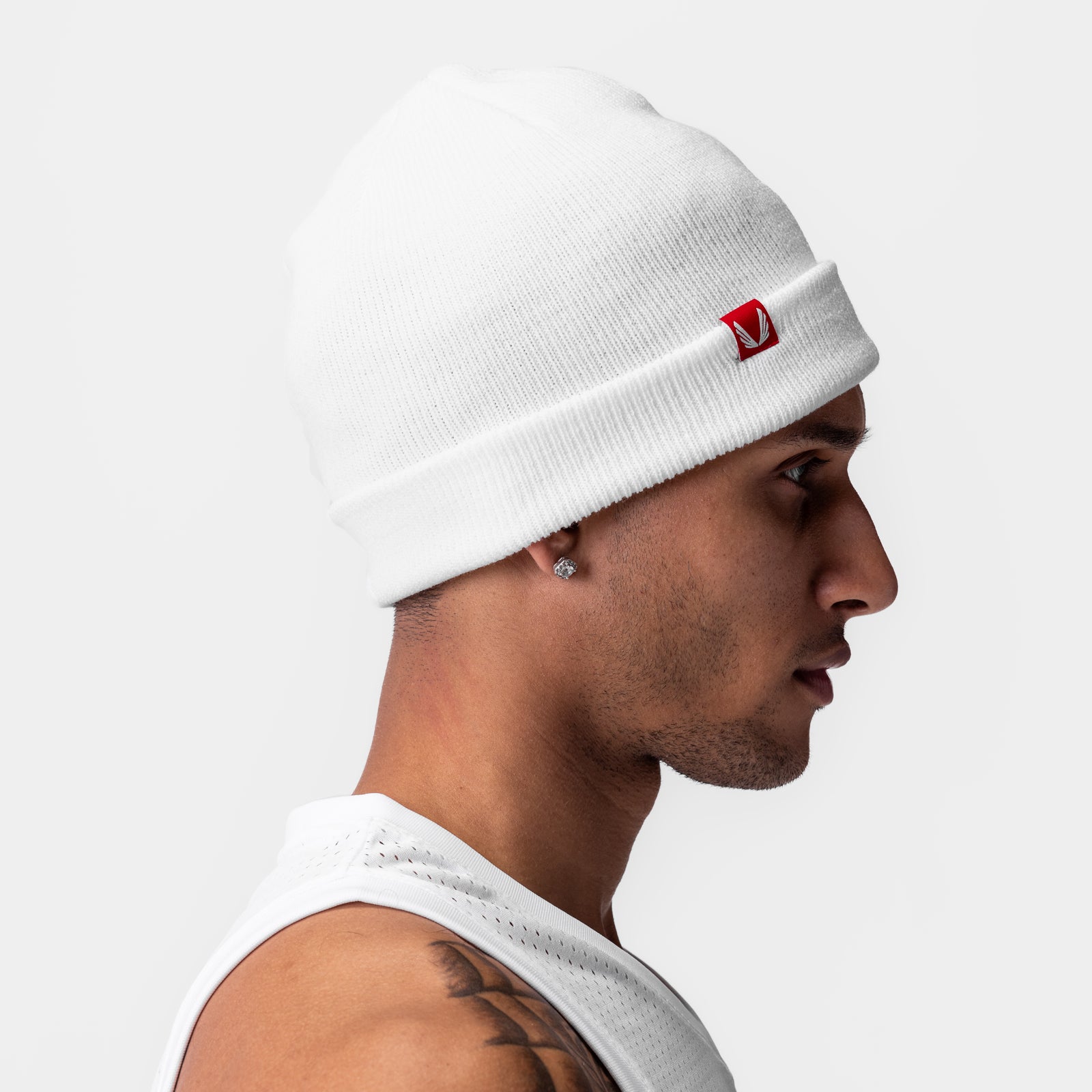 Essential Beanie in white worn by male model in profile view