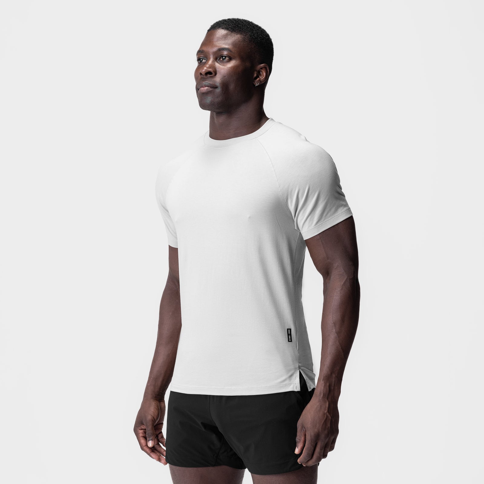 White Supima® fitted tee worn by model, paired with black shorts, front-facing pose