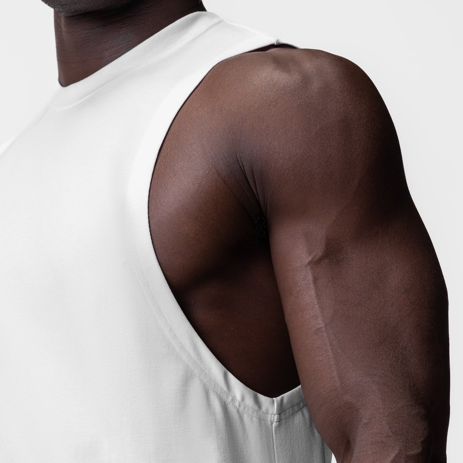 White Supima® Muscle Tank worn by model, side view showing fit