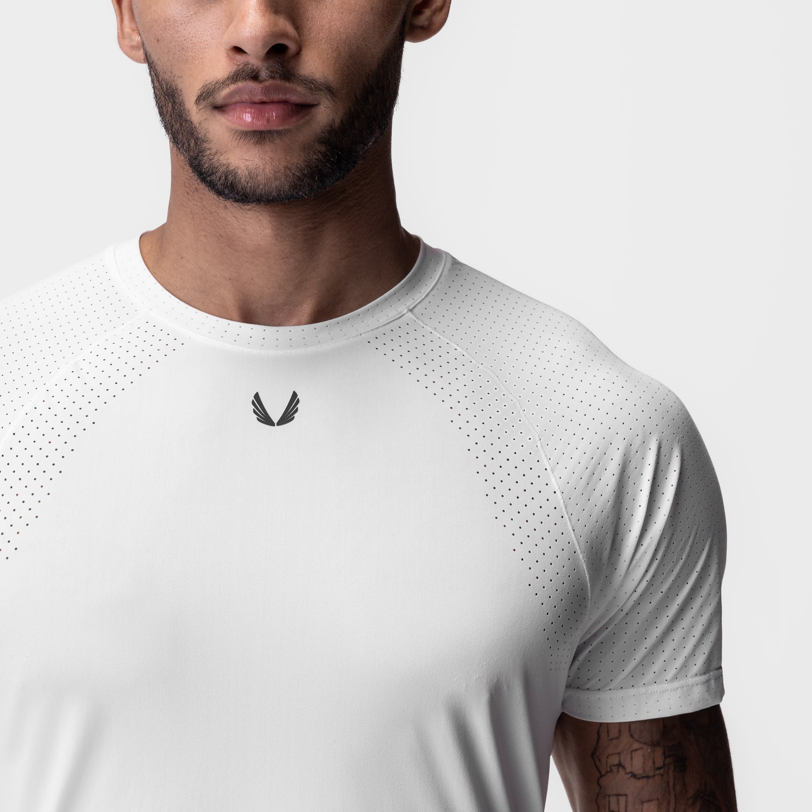 White Laser-Vent Established Tee worn by model, front view with perforated design detail