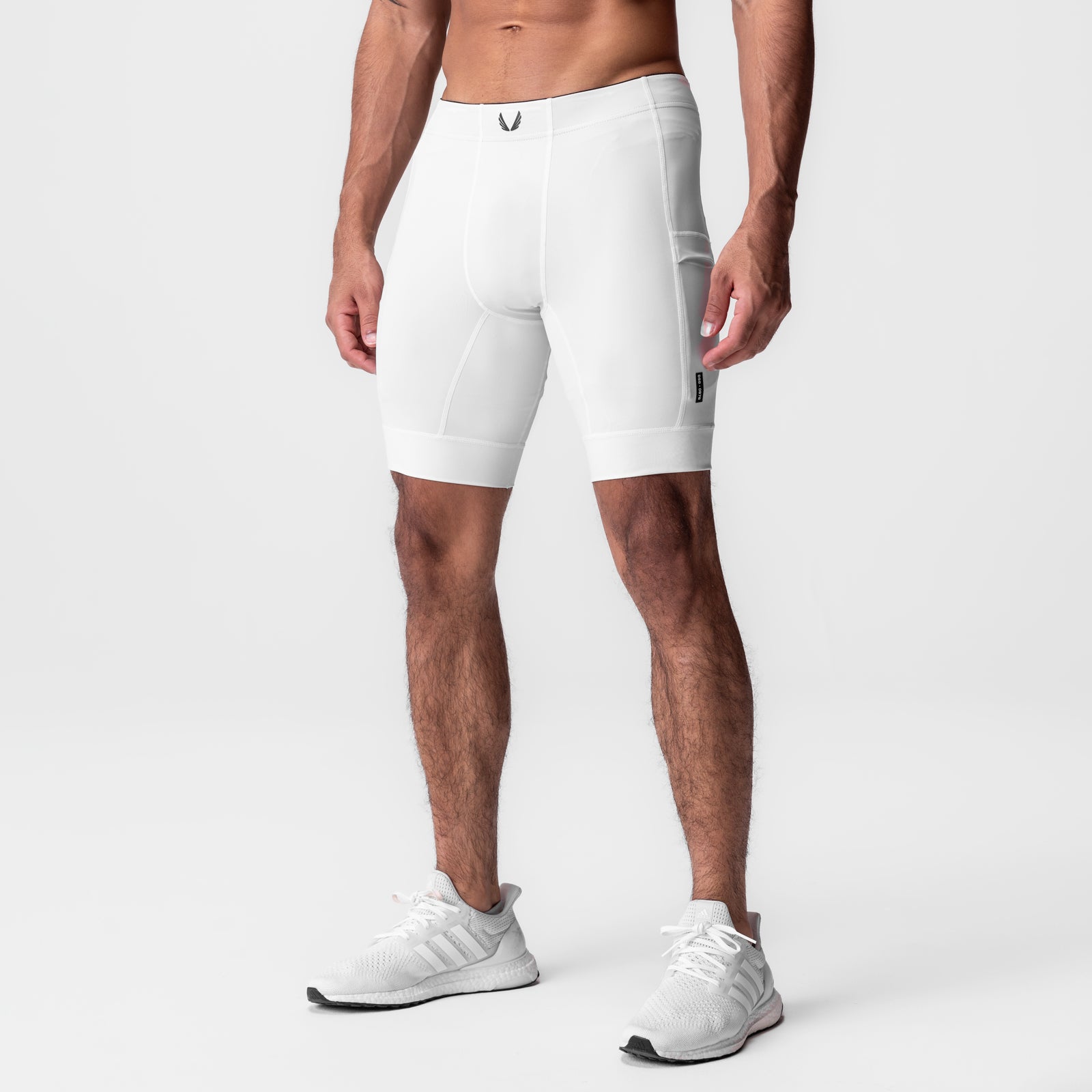 White WarpFlexx-Lite 1/2-length legging shorts on male model, side view