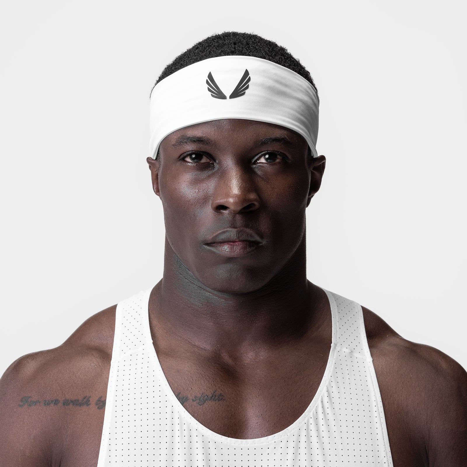 WarpFlexx Headband in white with wings logo, worn by male athlete in white tank top