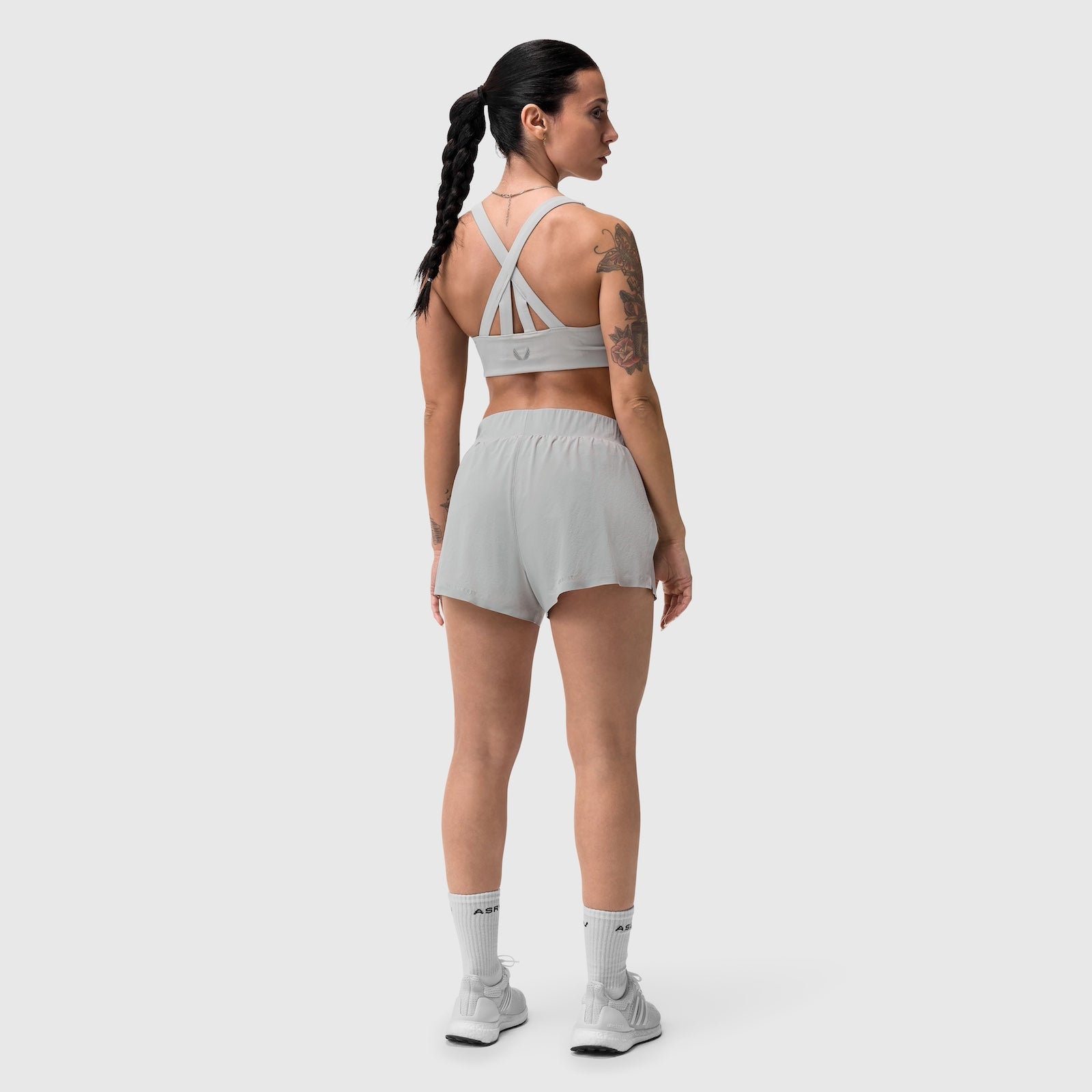 Aerotex Side Split Run Short in Slate Grey, back view on model with sports bra