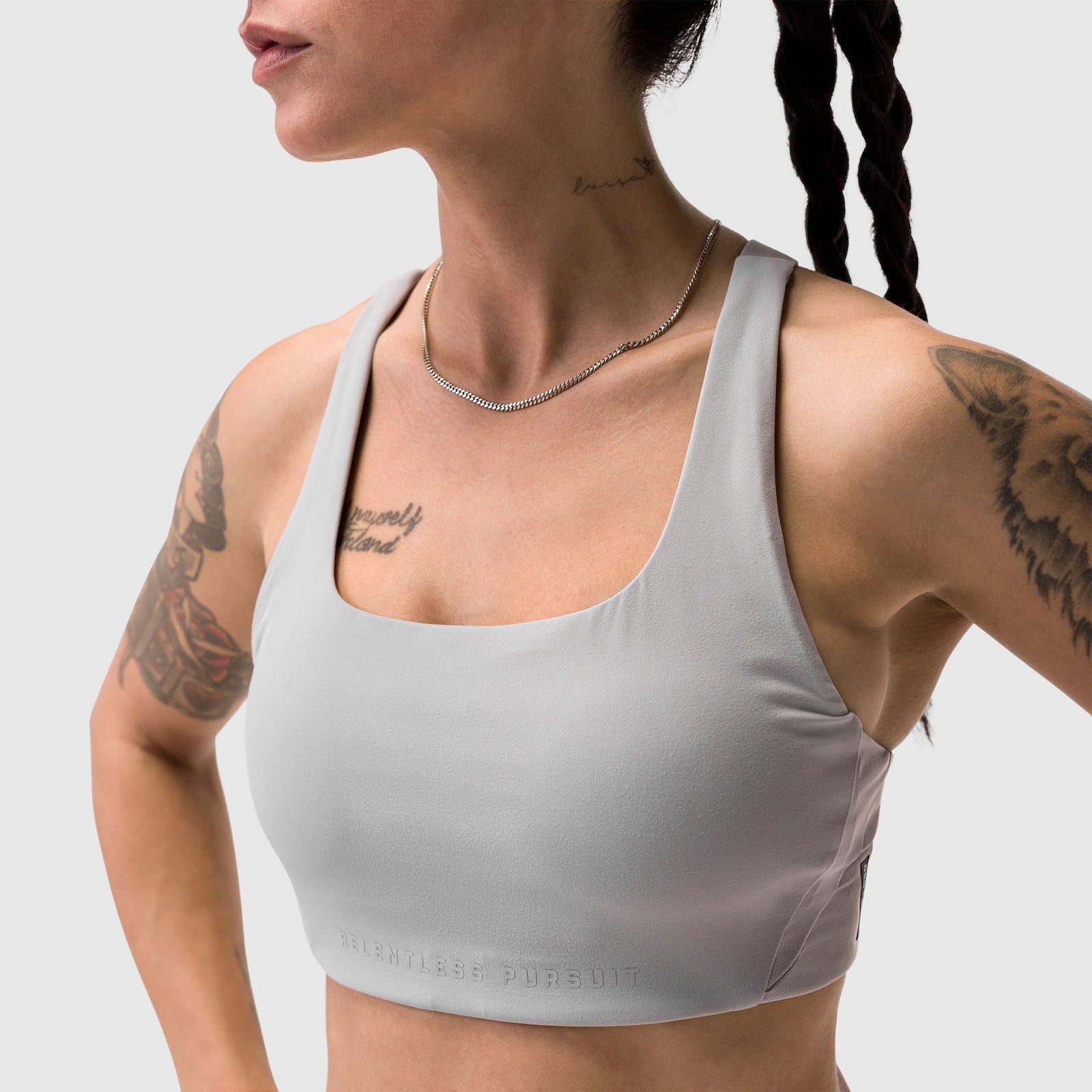 Slate grey Lycra hybrid sports bra worn by model with tattoos, front view