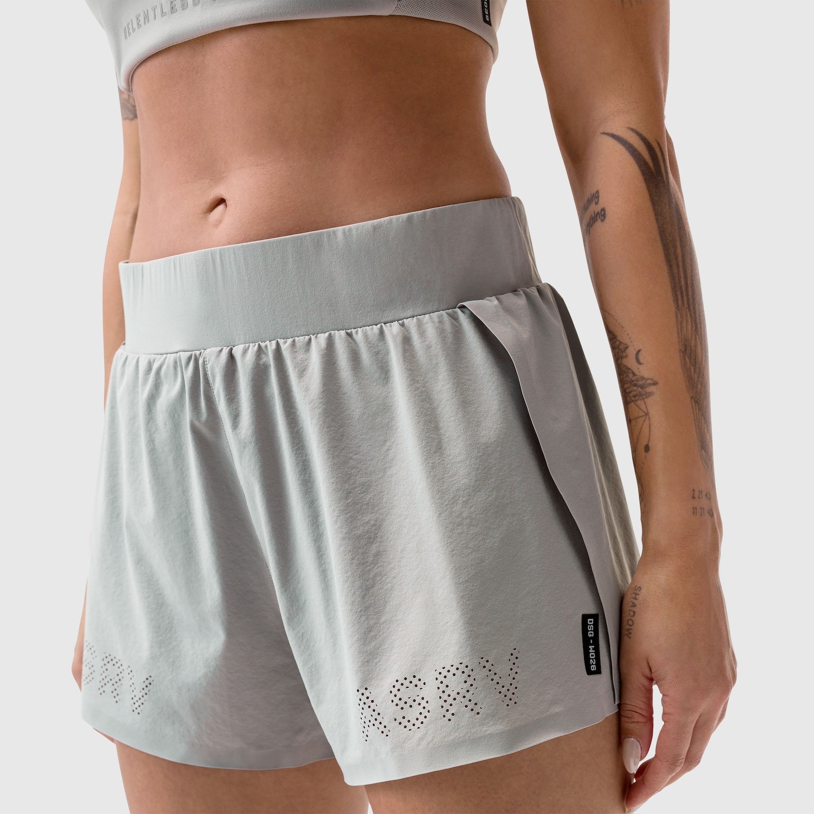 Aerotex Side Split Run Short in slate grey, worn by model showing front view with perforated logo detail