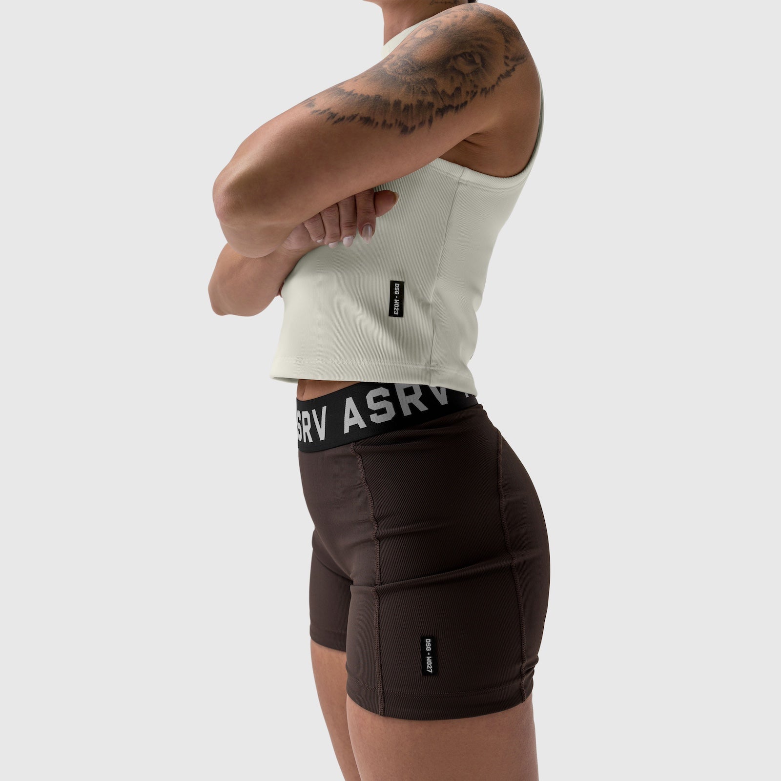 Lycra ribbed mockneck tank in ivory cream worn with black shorts, side view