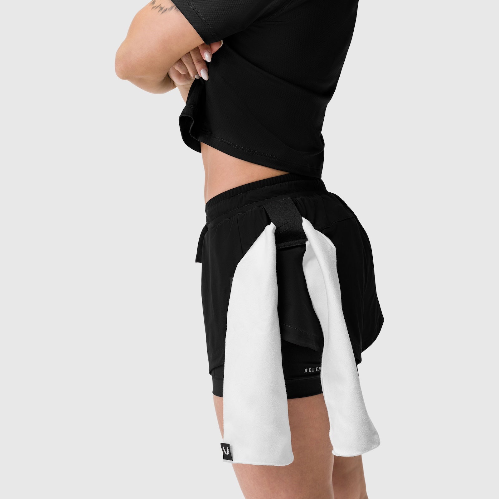 Tetra-Lite® Liner Short in black worn by model with white towel accessory, side view