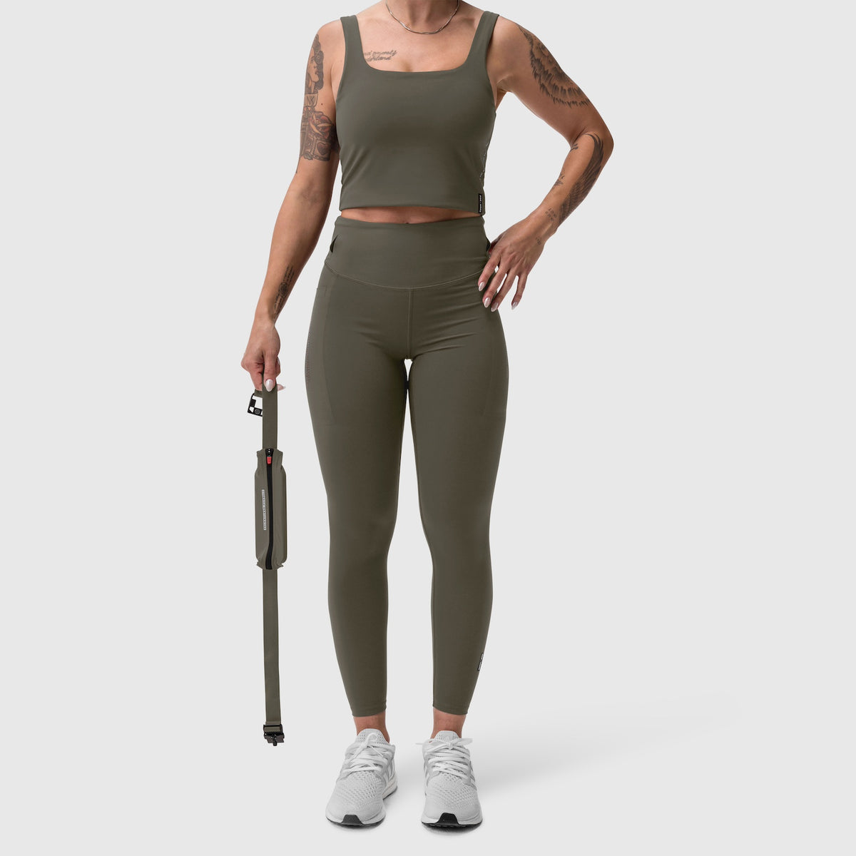 W030 LYCRA® 3-in-1 Legging in olive, worn with matching crop tank top and white sneakers