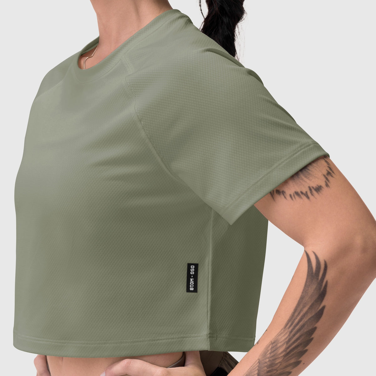 AeroSilver Cropped Tee in sage worn by model showing side view and fit