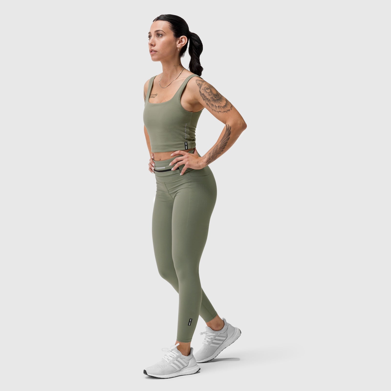 W030 LYCRA® 3-in-1 Legging in sage, worn by model standing in profile