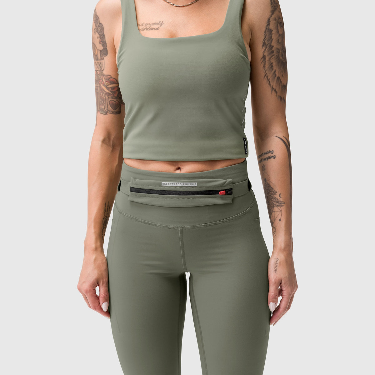 W030 Lycra 3-in-1 Legging in sage worn with matching crop tank and belt bag