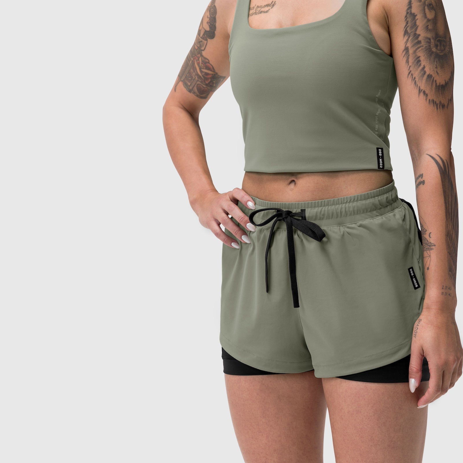 Tetra-Lite Liner Short in sage worn by model, front view with black underlay shorts