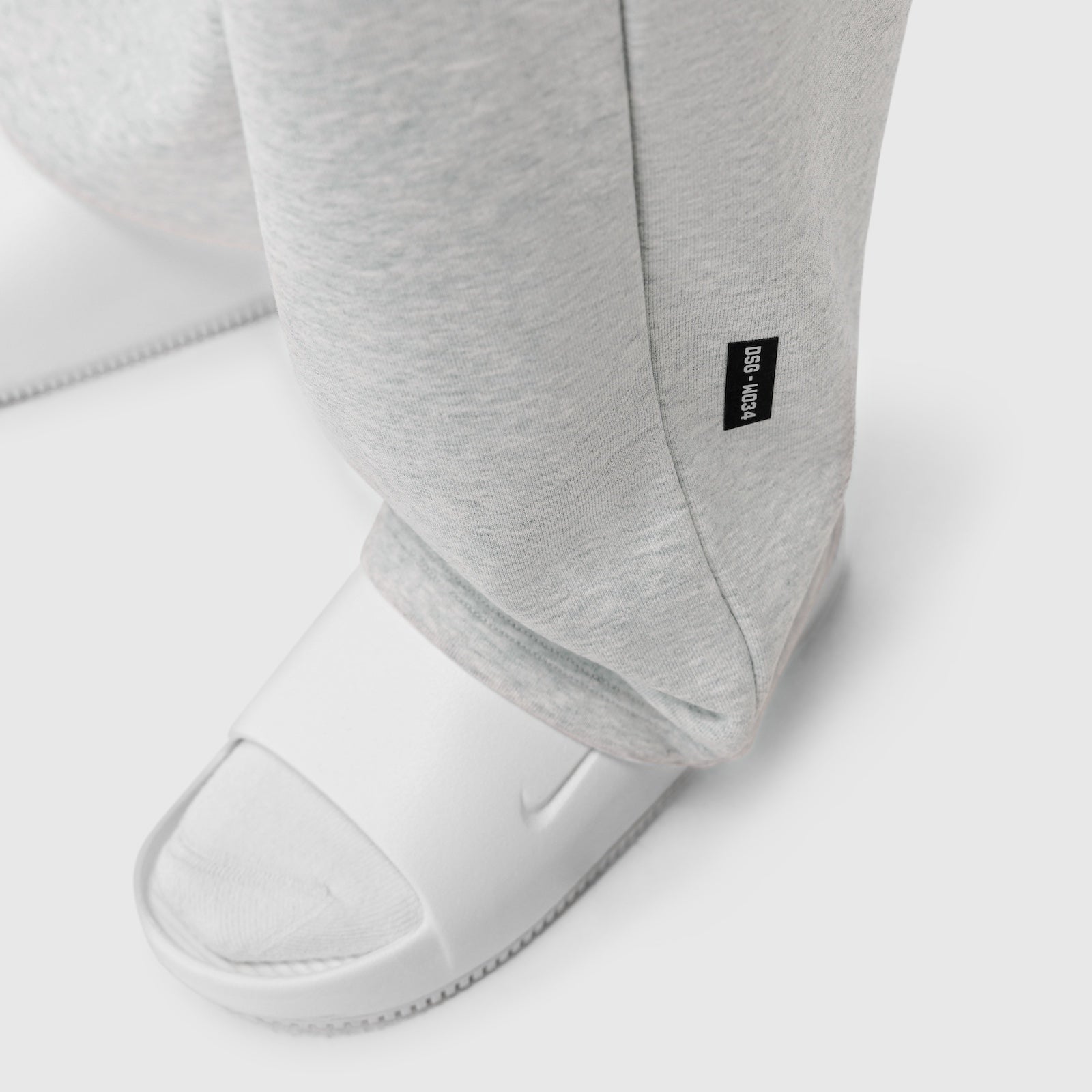 Heather grey Sorona Terry straight leg sweats on model wearing white slides, detail view