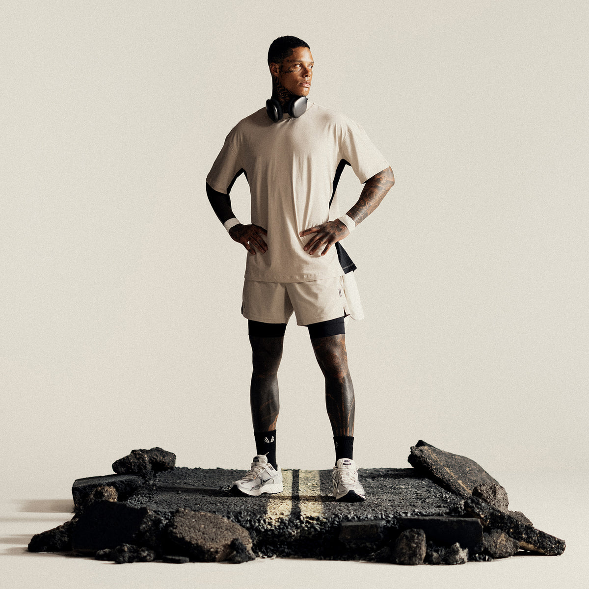 Ultralite™ 6" Liner Short in beige and black, worn by model standing on rock