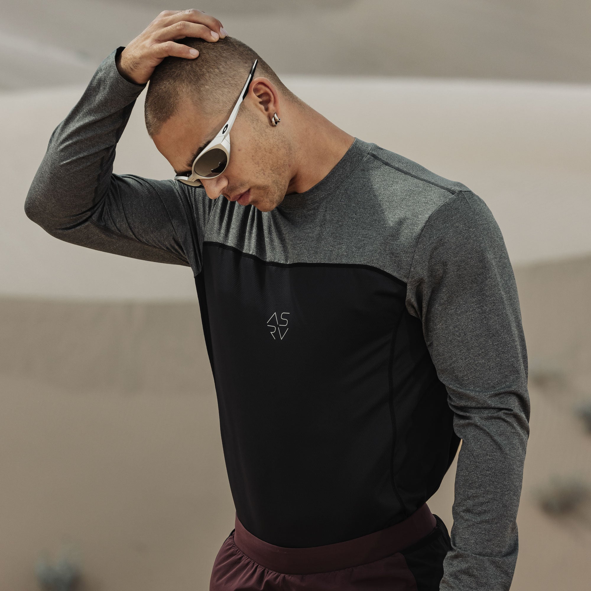 AEROSILVER UPF50+ Run Long Sleeve in black and gray colorblock, worn by model outdoors