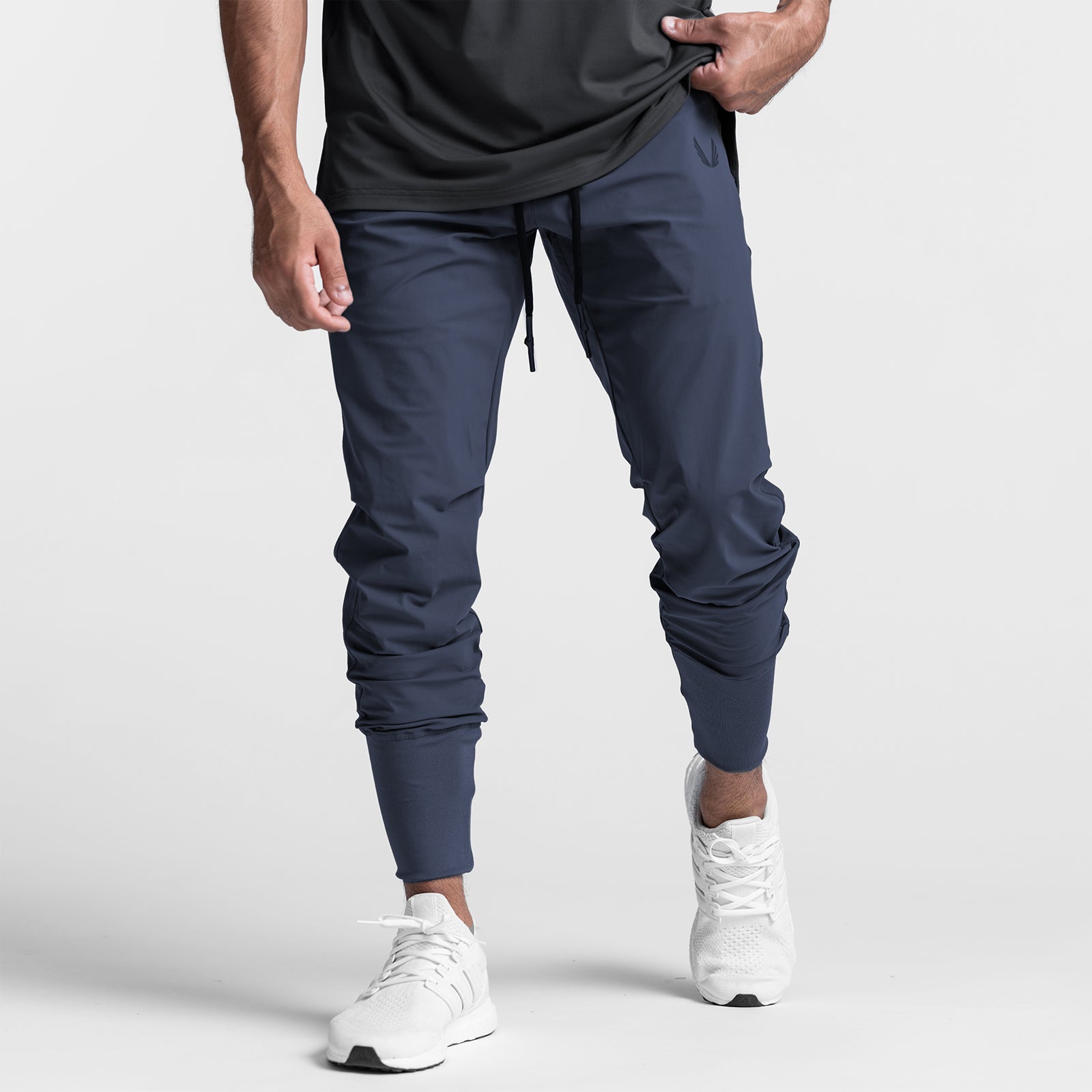Tetra-Lite High Rib Jogger in navy worn by model with white sneakers, front view