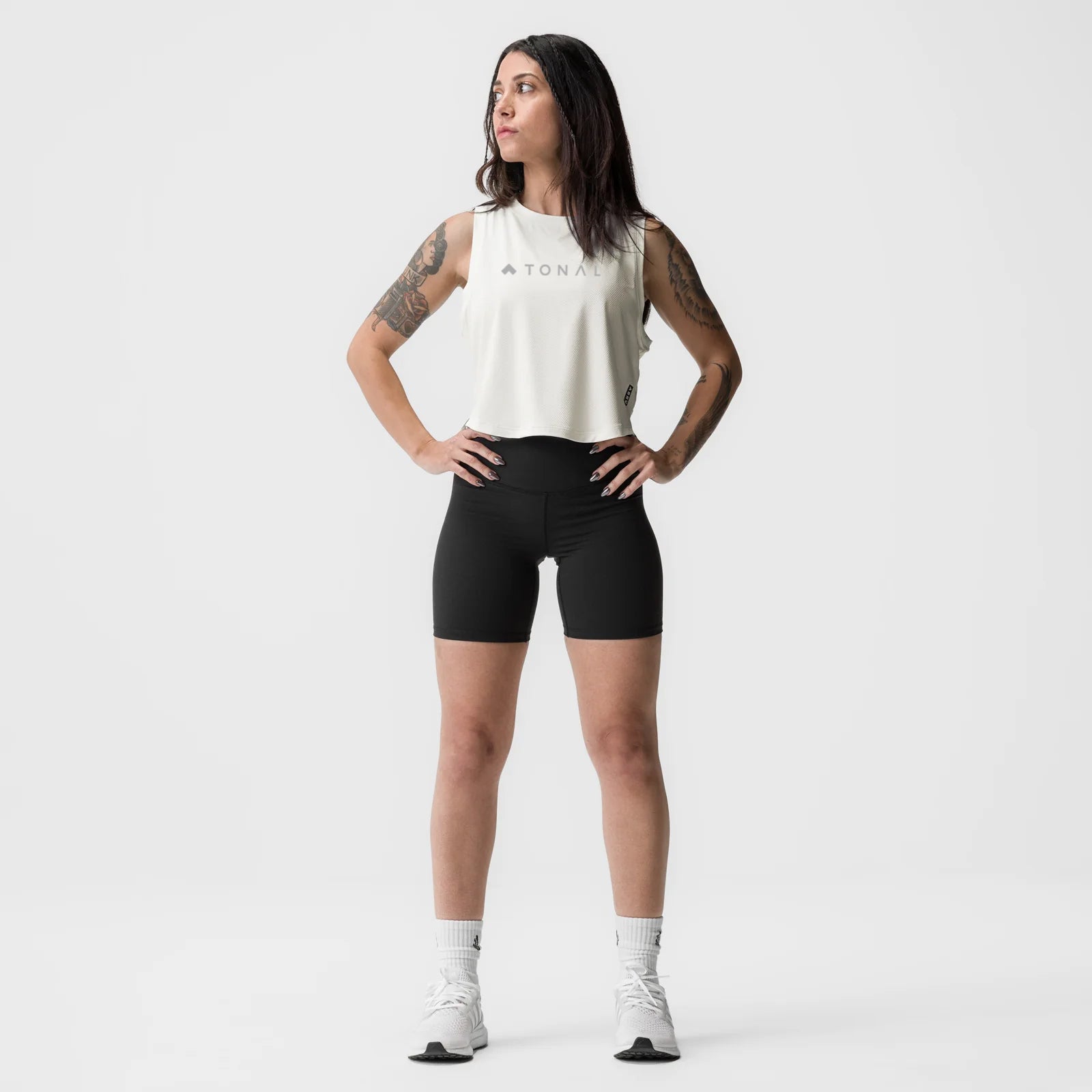 Ivory cream cropped training tank on model, paired with black shorts and white socks, front facing