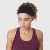 Ice-Skin Performance Headband in black worn by model with curly hair, front view