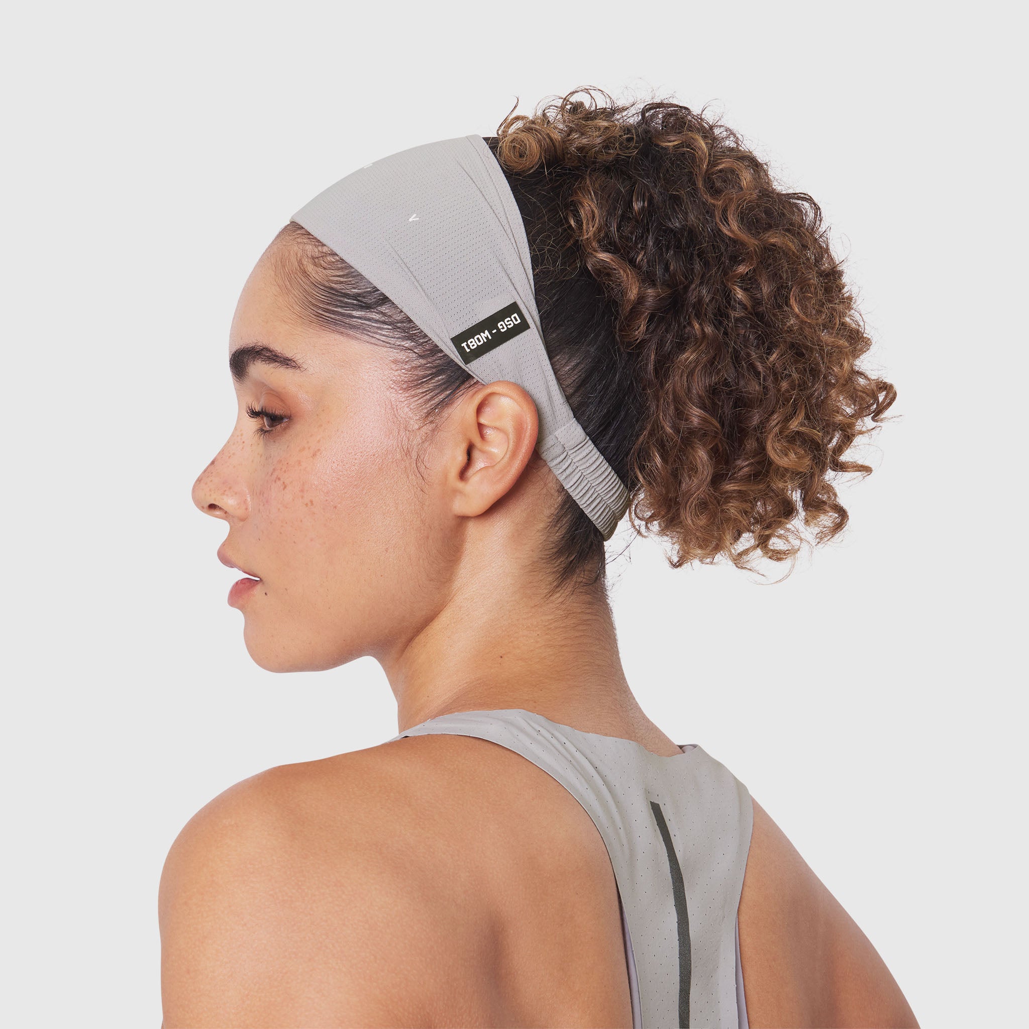 Ice-Skin Performance Headband in Slate Grey, worn by model in profile view