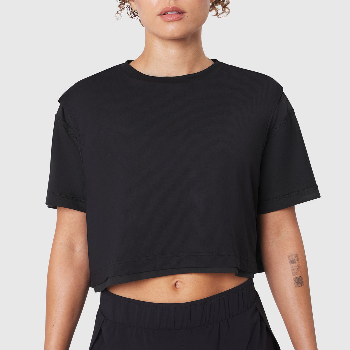 SUPIMA® Ice-Skin™ Reversible Crop Tee in Black worn by model, front view