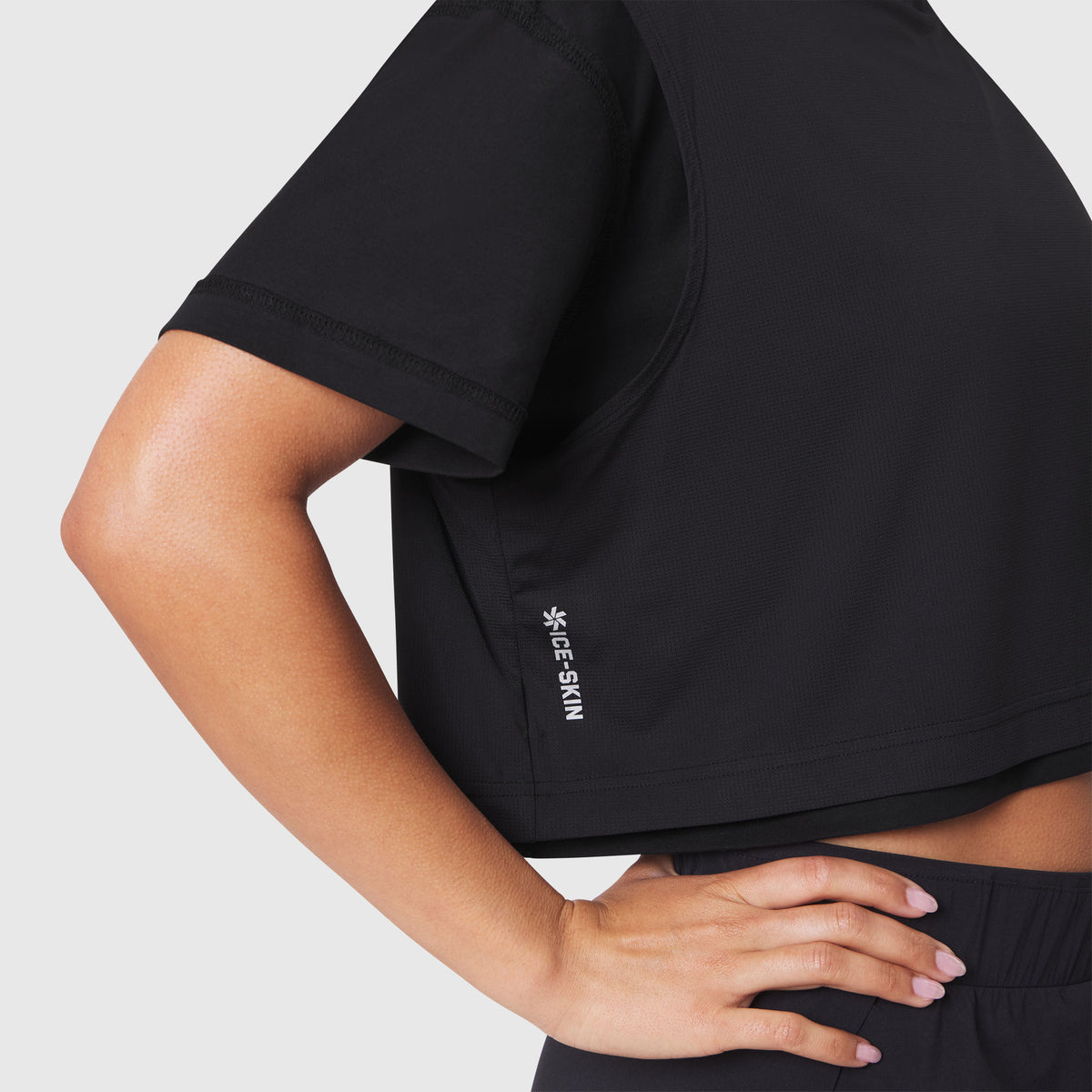 W082 Supima Ice-Skin Reversible Crop Tee in black, worn by model, side view