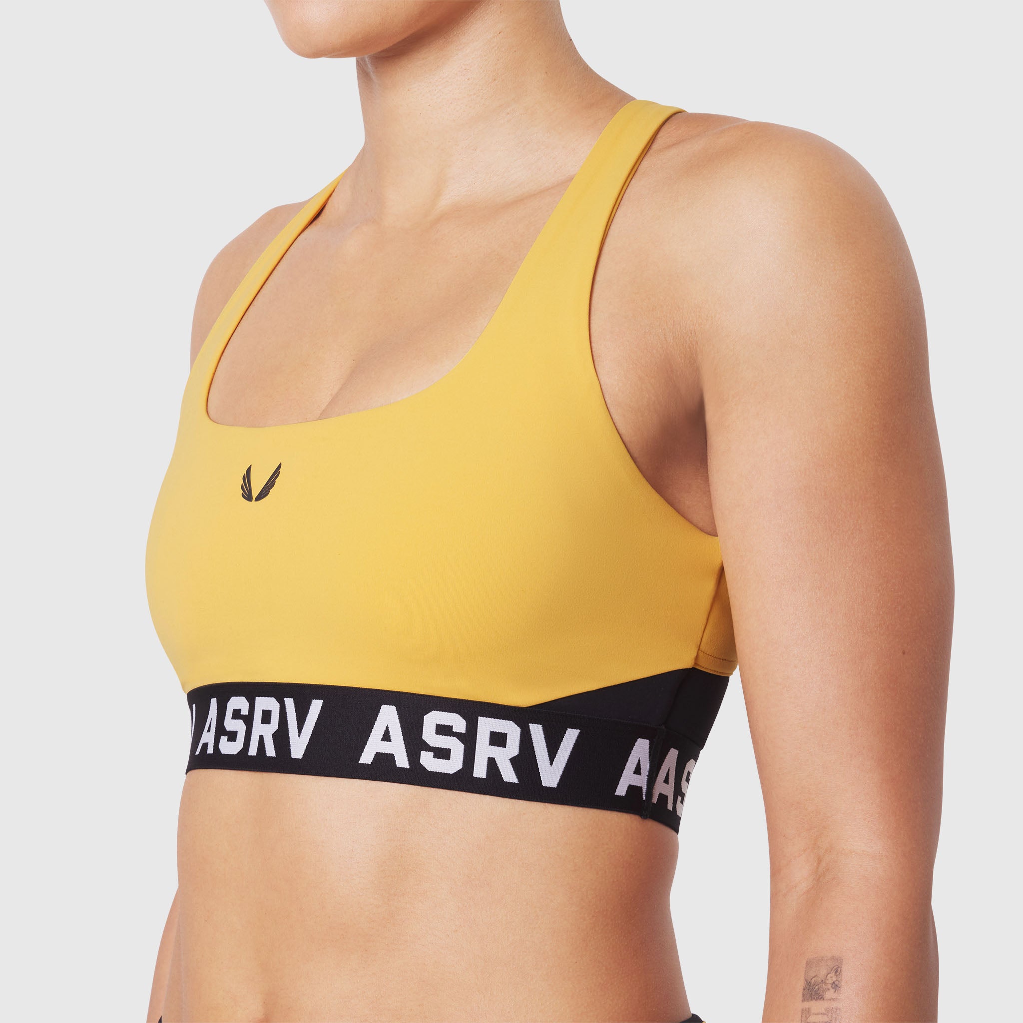W083 LYCRA® ADAPTIV Racerback Sports Bra in Amber, front view on model