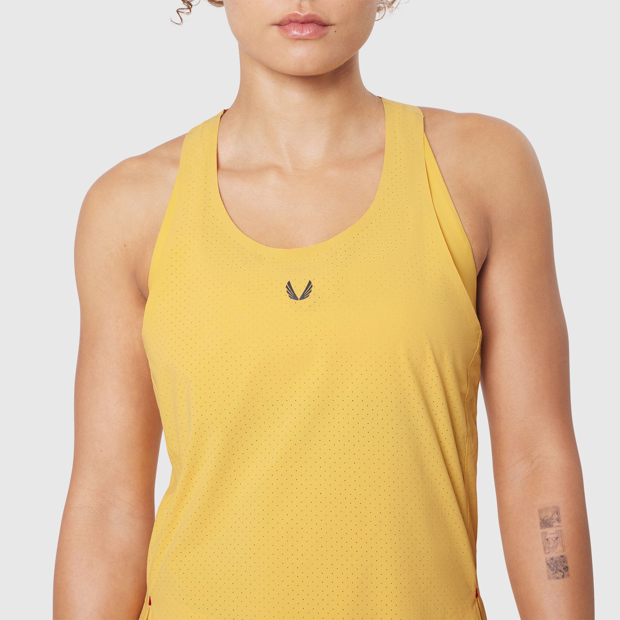Aerotex™ Perforated Run Tank in Amber, modeled on woman, front view