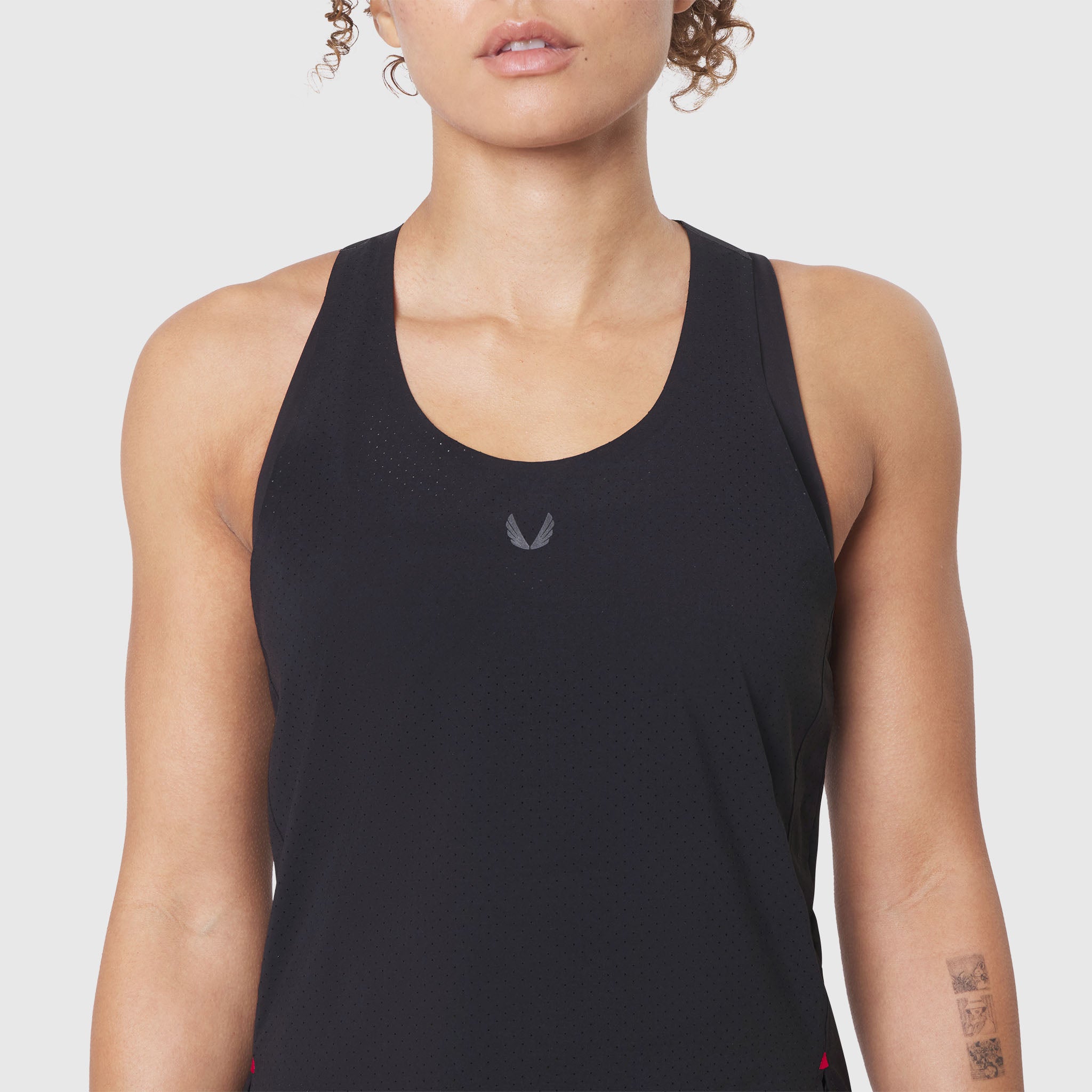 Aerotex Perforated Run Tank in black, front view on model