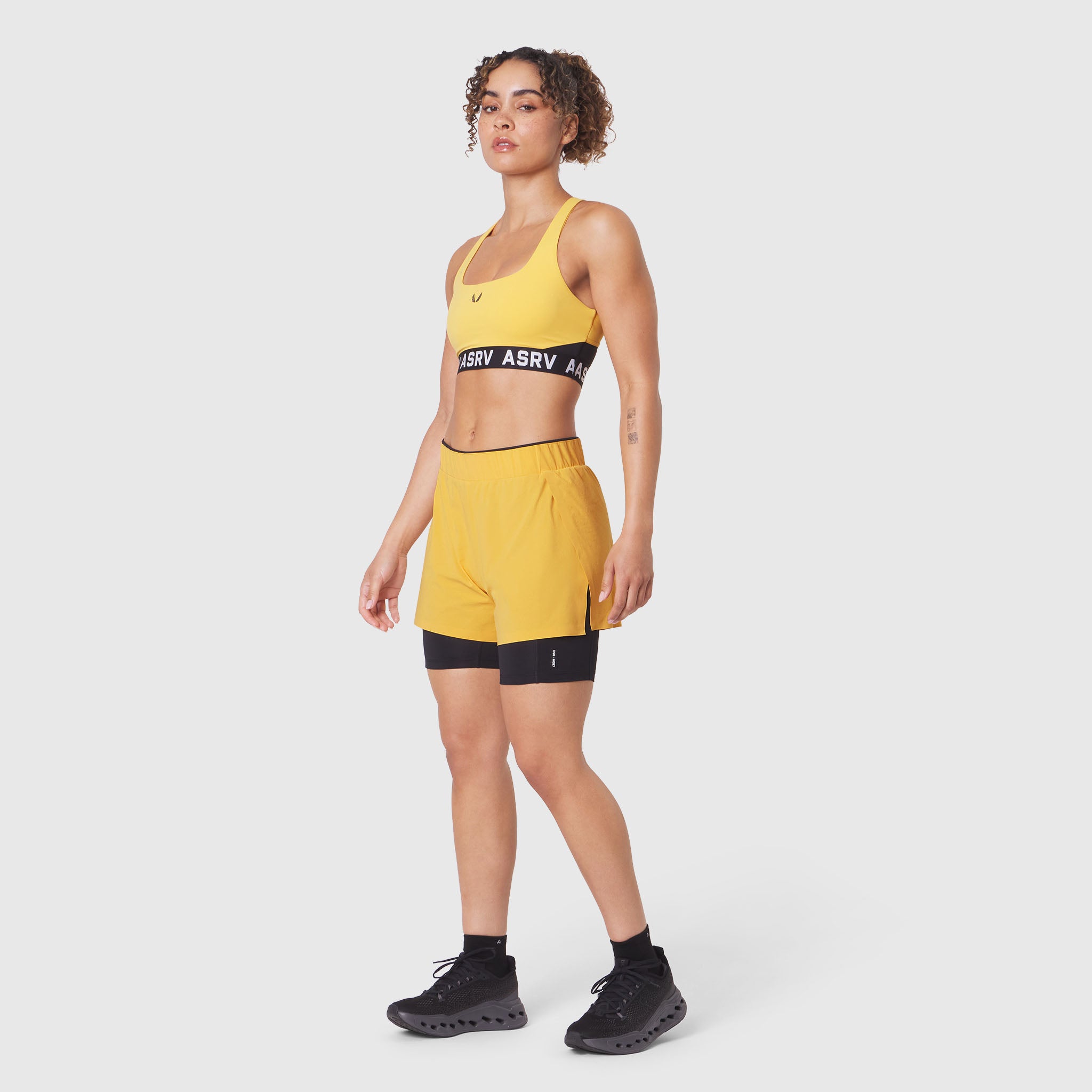 W087 Aerotex Side Split Liner Short in amber, worn with matching sports bra