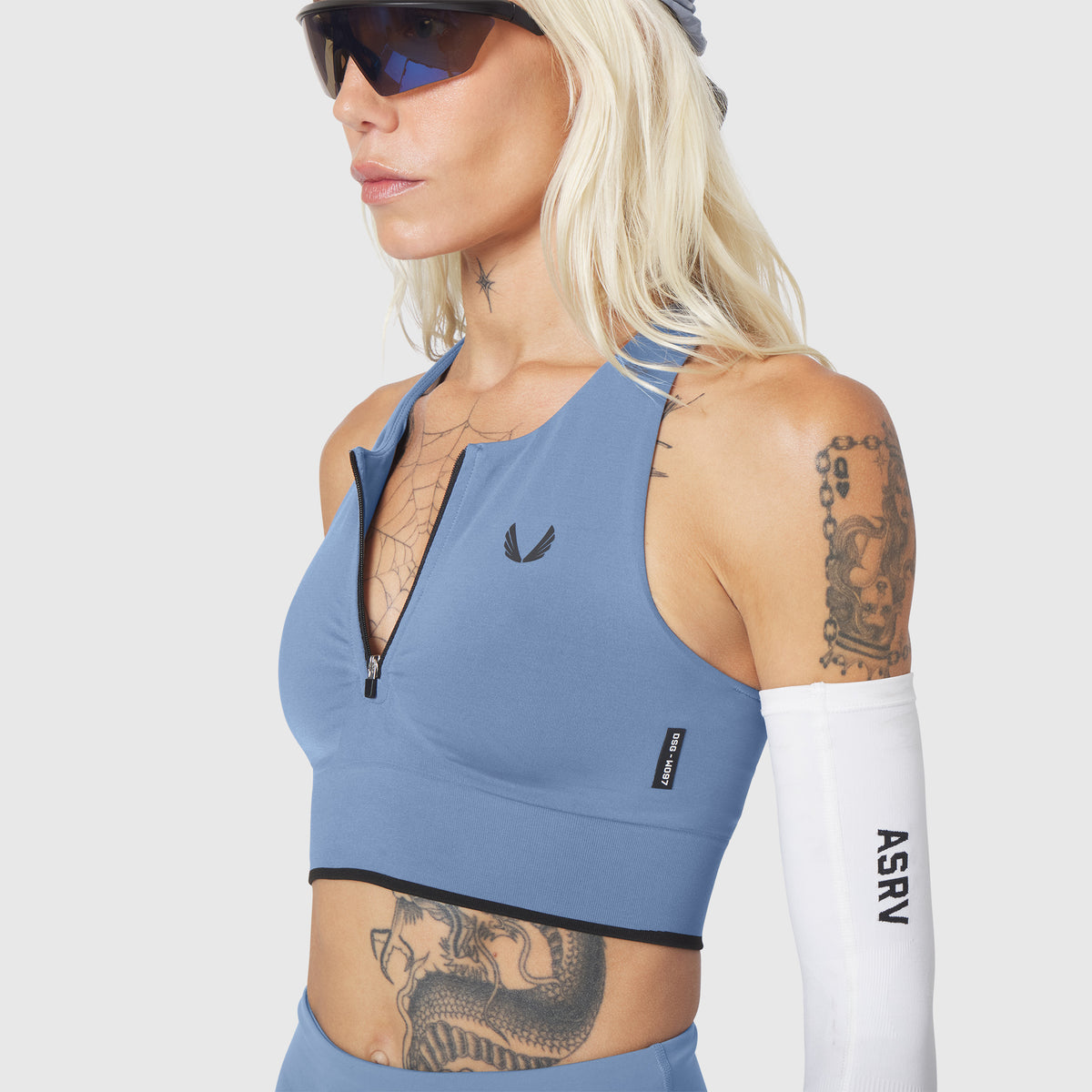 W097 LYCRA® ADAPTIV Seamless Zip Bra in Slate Blue, worn by model, front view