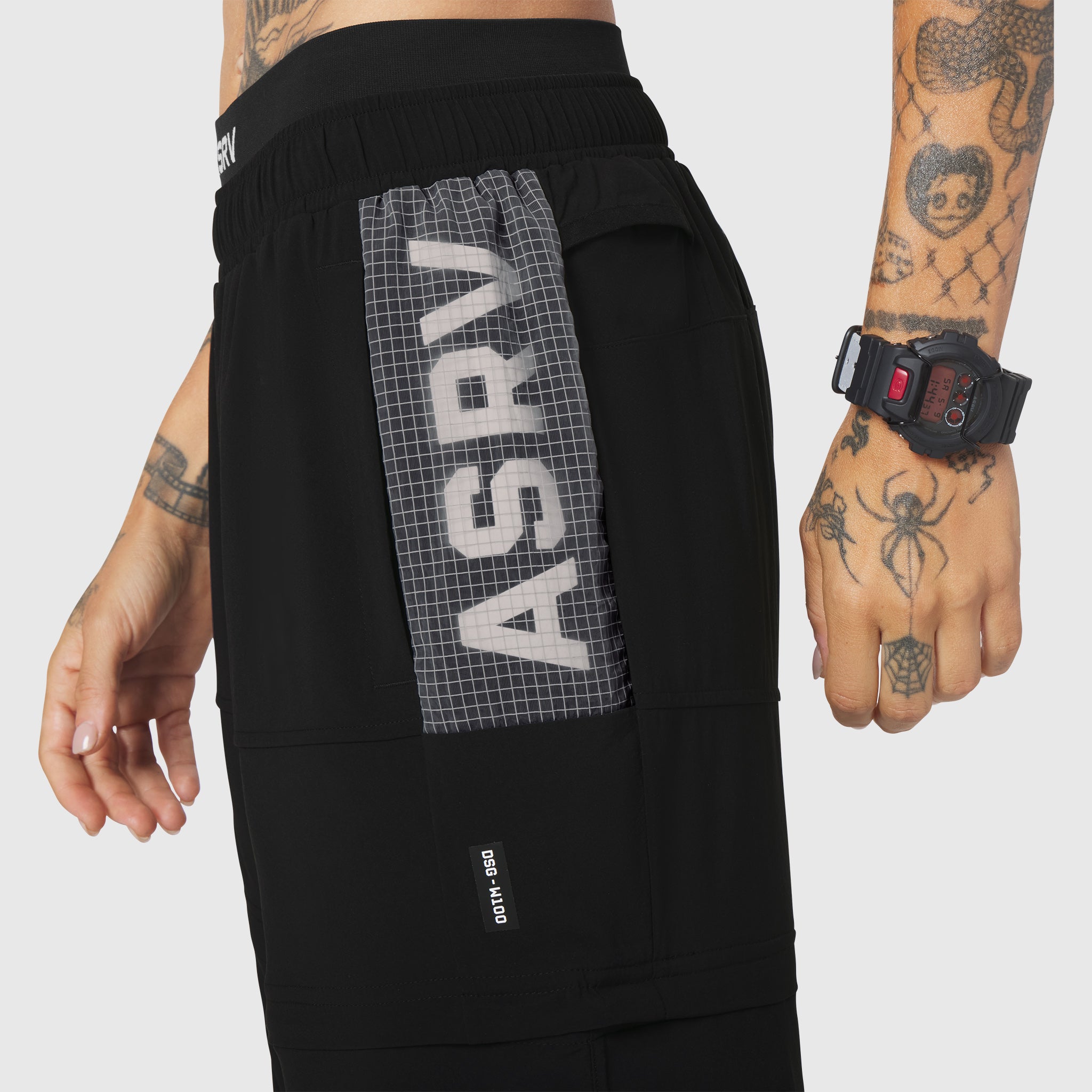 W100 2-in-1 Convertible Pant in Black, worn by model showing side view