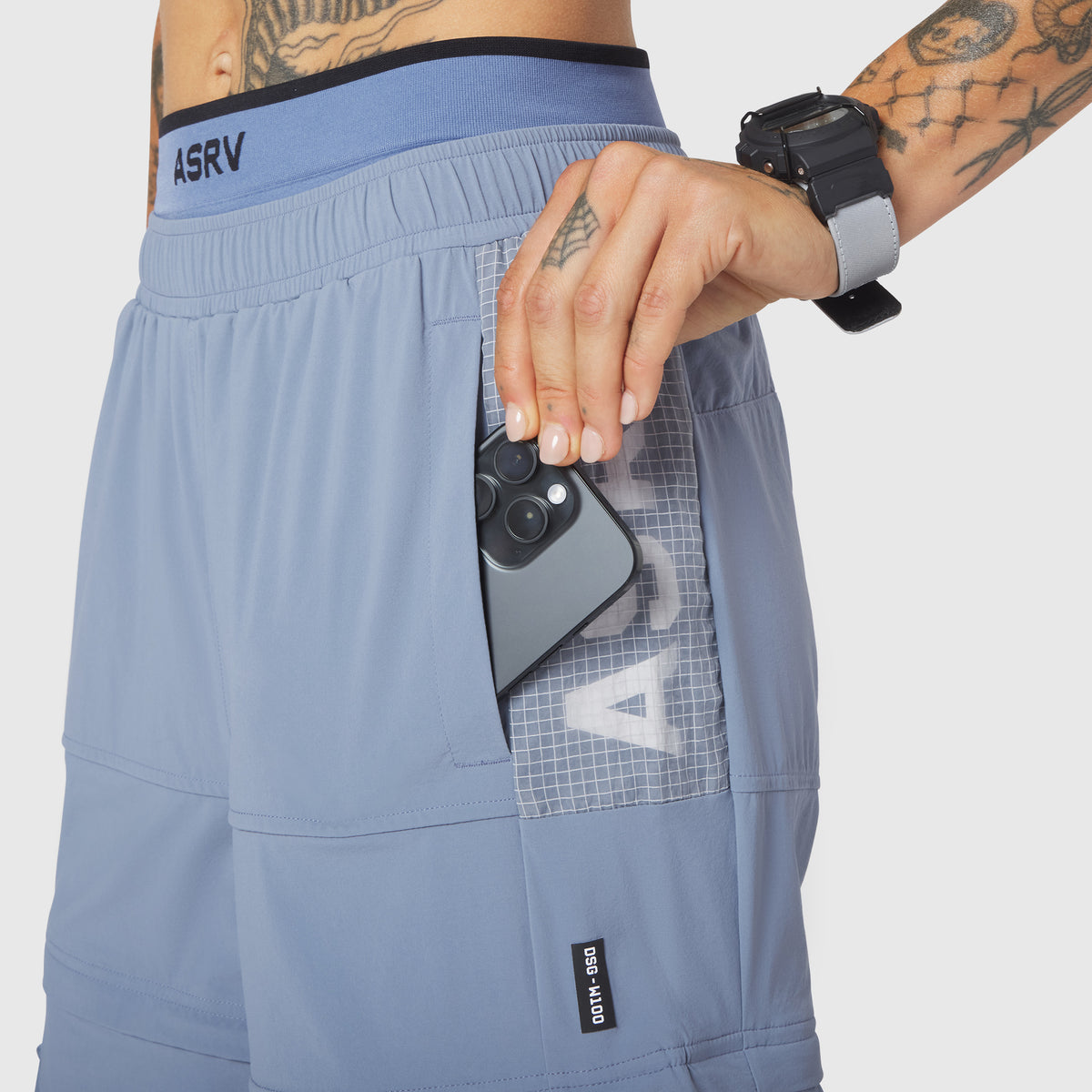 W100 2-in-1 Convertible Pant in Slate Blue, worn with phone in pocket