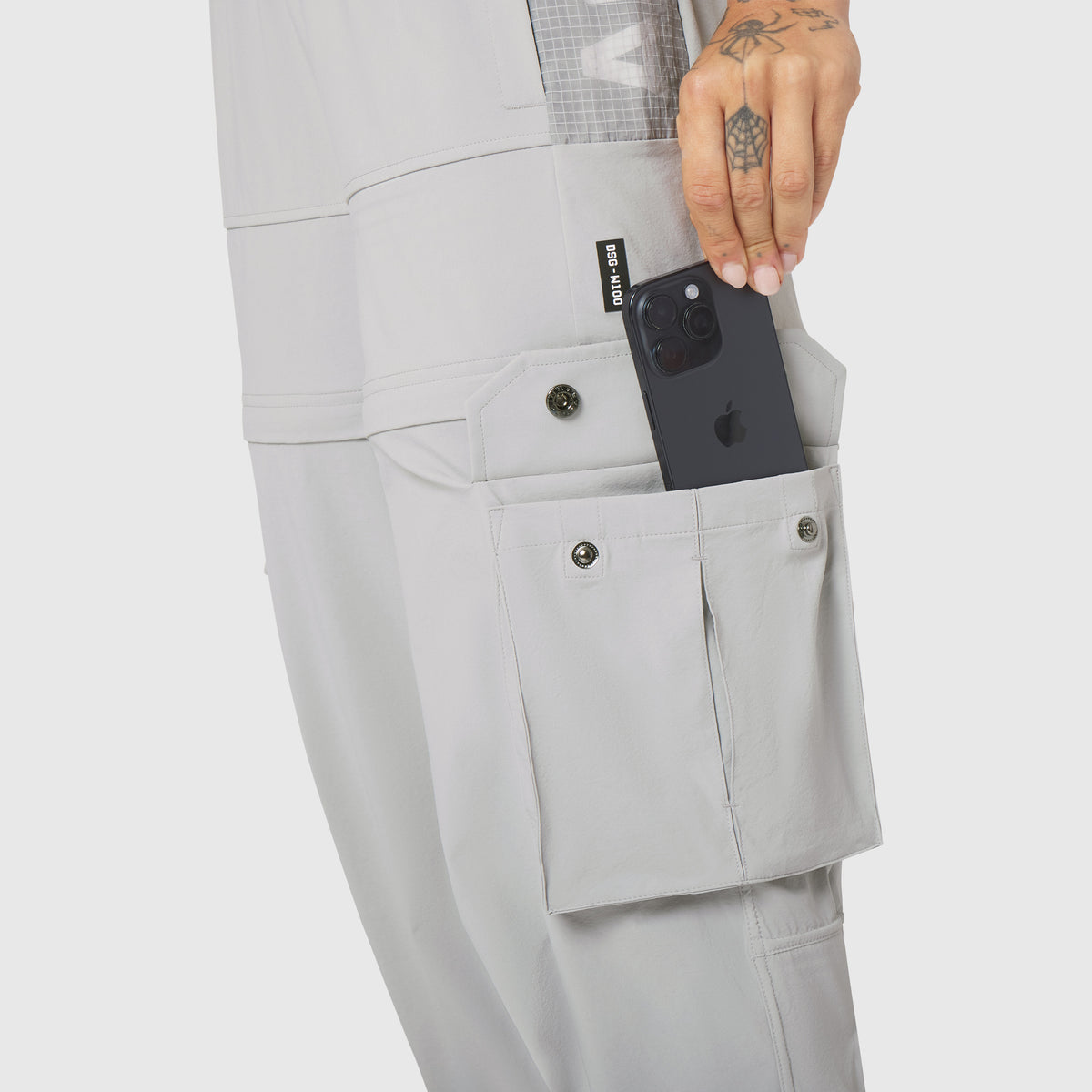 W100 2-in-1 Convertible Pant in Slate Grey, worn with phone in cargo pocket