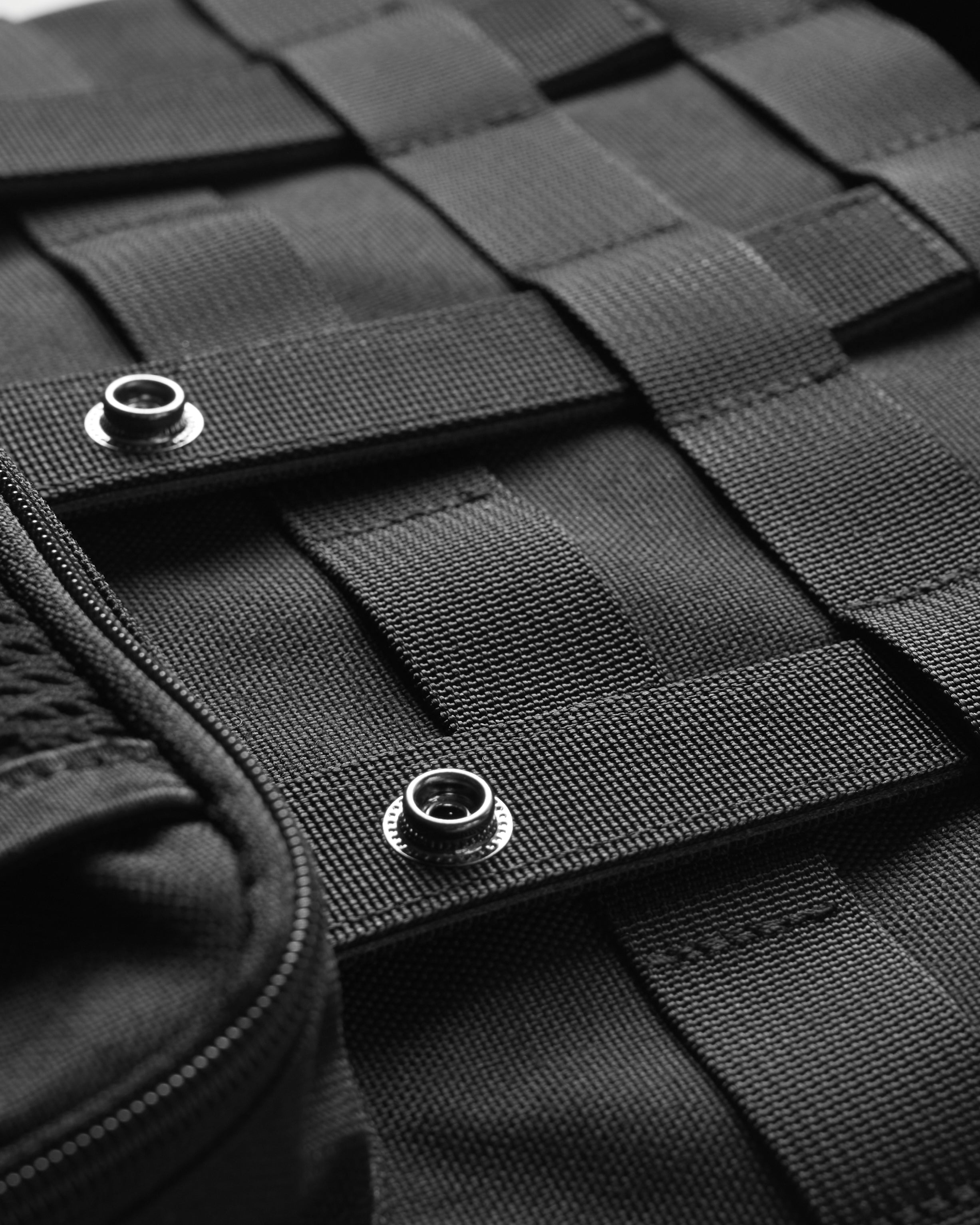 Flatlay Cordura® Modular 2-in-1 Crossbody Backpack in black, detail view of snaps and quilted texture