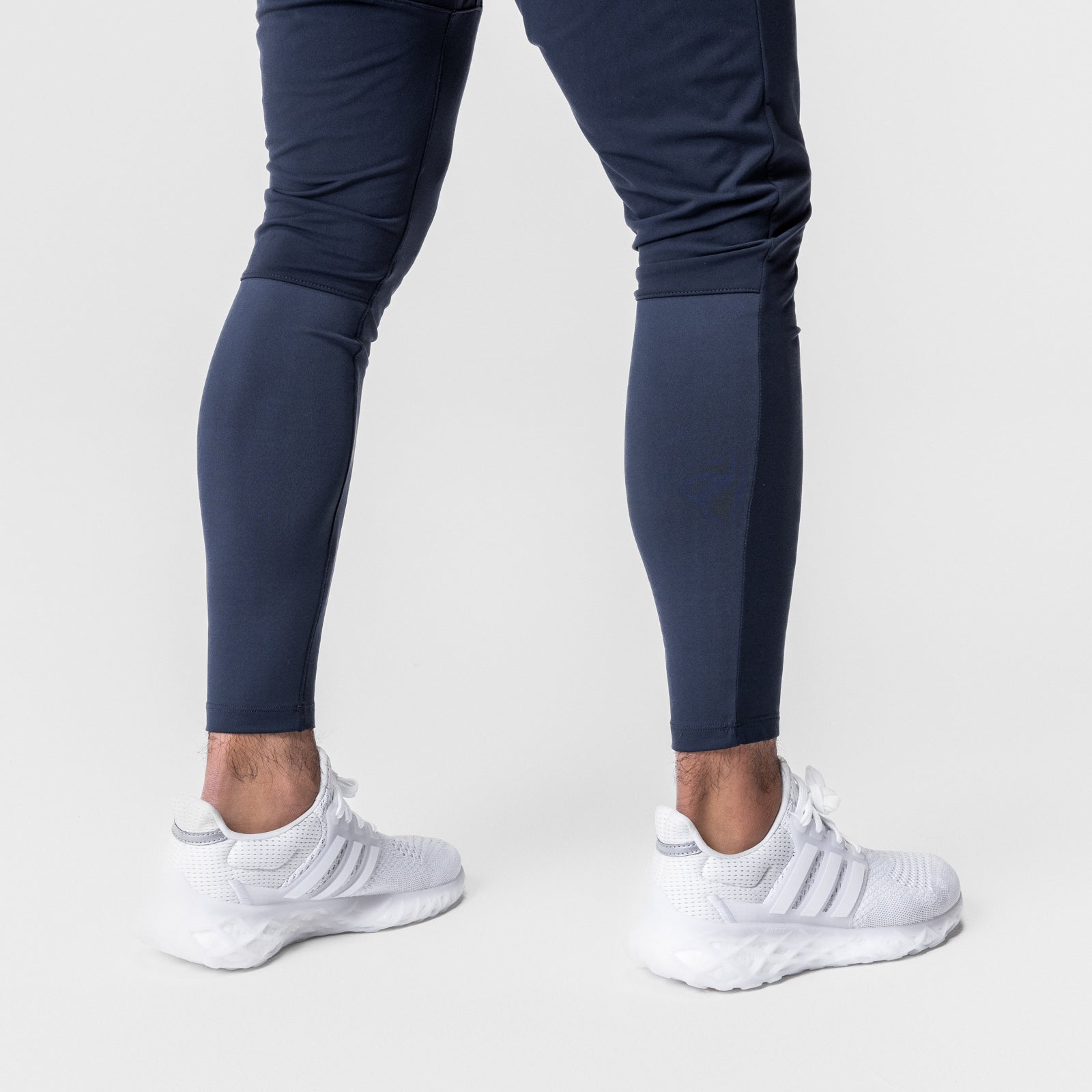 Thermal Hybrid Jogger in navy worn with white sneakers, lower body view