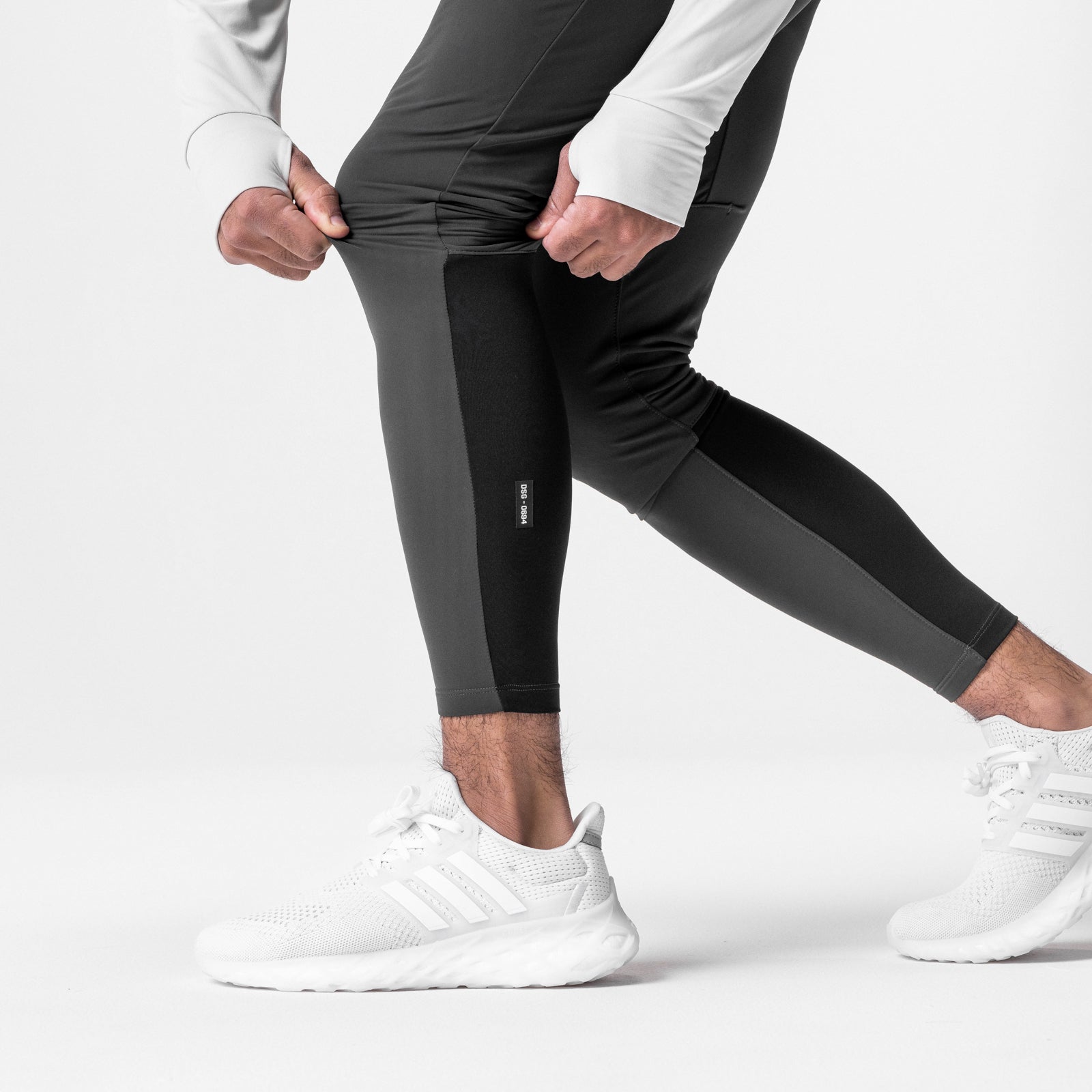 Thermal Hybrid Jogger in space grey, worn by model in running pose with white sneakers