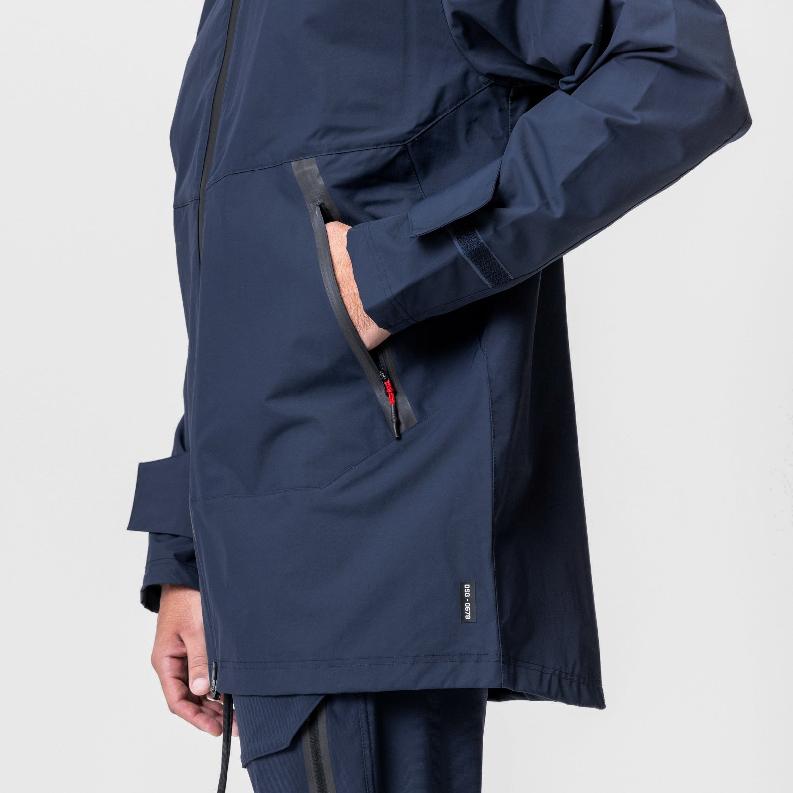 Navy Hipora® Tech Parka worn by model, side view showing sleeve detail and zipper