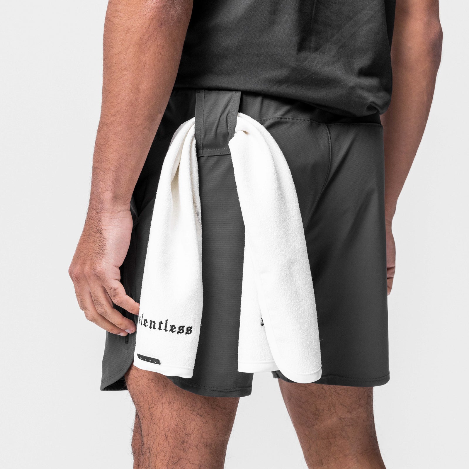 Tetra-Lite® 7" Tech Short in Space Grey worn by model, holding white towel