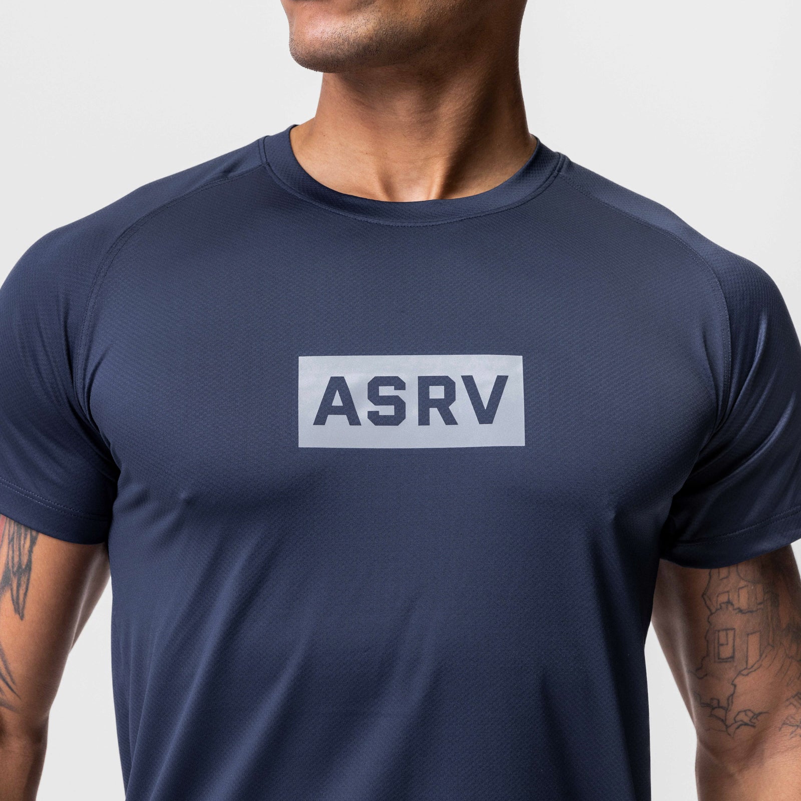 AeroSilver Established Tee in navy with white box logo, worn by model