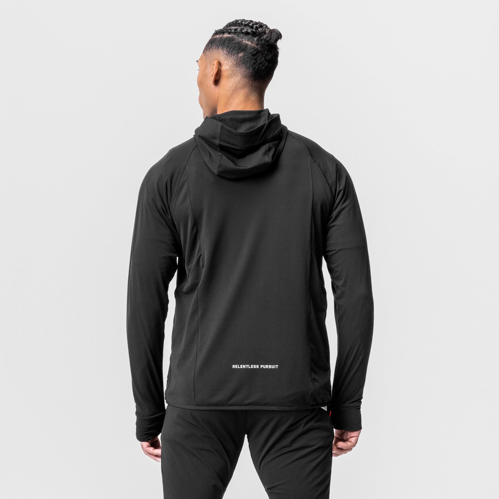 Black training hoodie worn by model, back view showing 'Relentless Pursuit' text