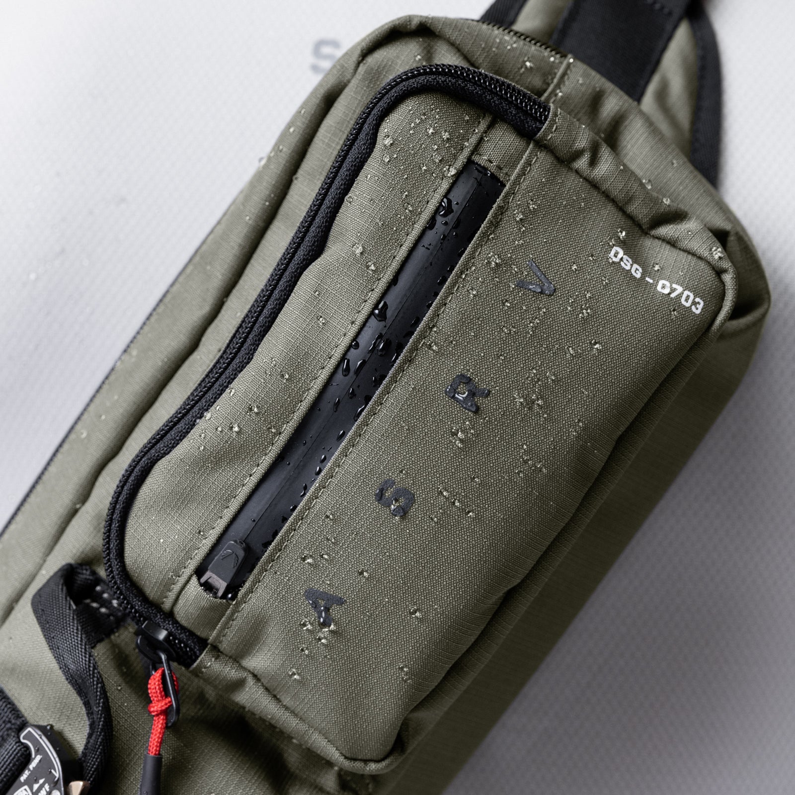 0703 Cordura Tech Crossbody Pack in olive, being worn/carried