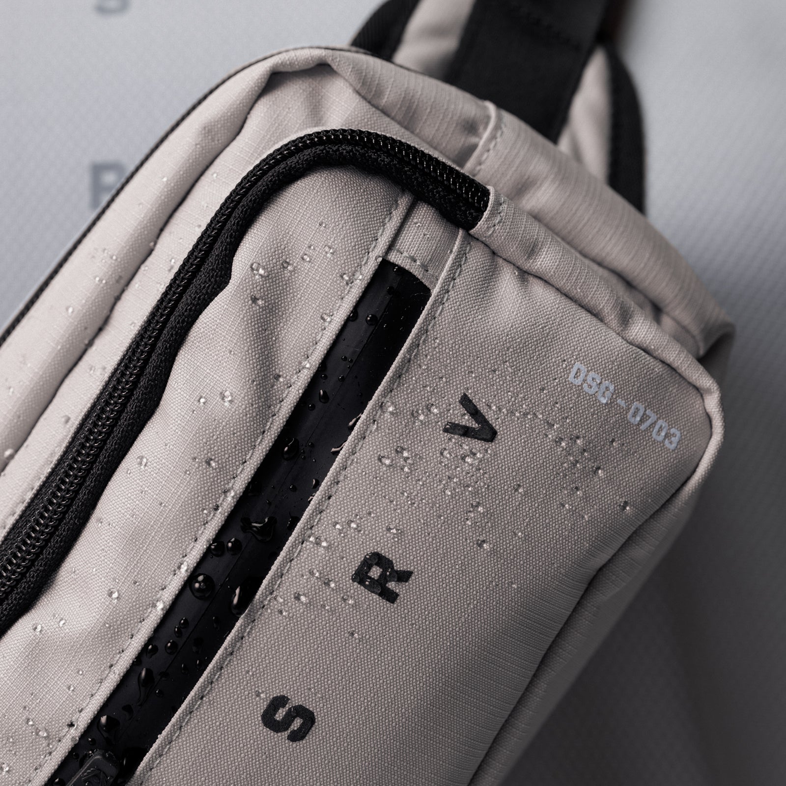 0703 Cordura® Tech Crossbody Pack in Chai, being carried on shoulder