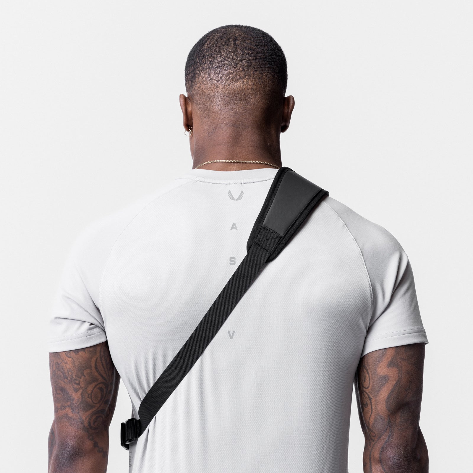 Waterproof Holster Sling Bag in black, worn across body on model from back view