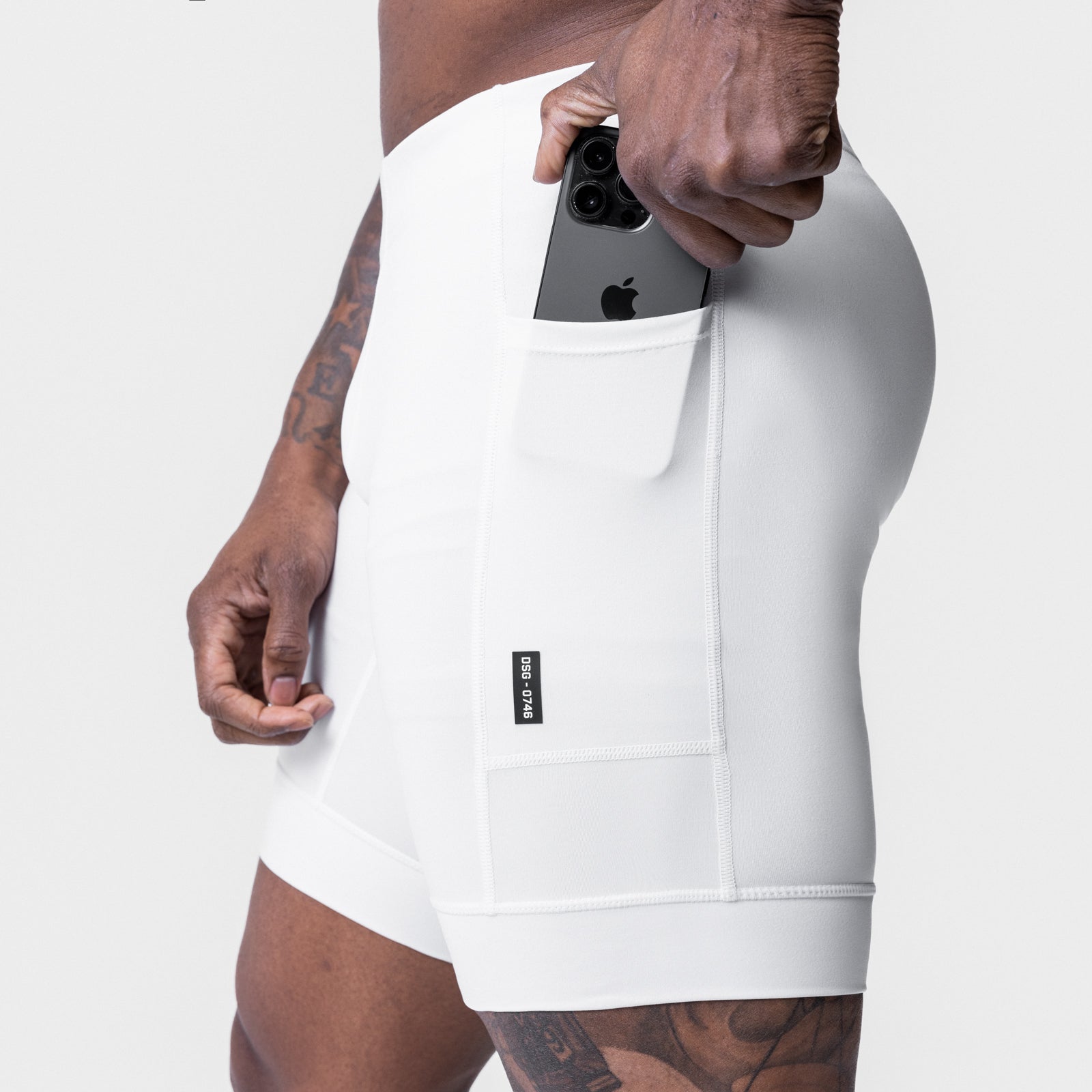 WarpFlexx® Side Pocket 1/2-Length Legging in white, model holding phone in side pocket