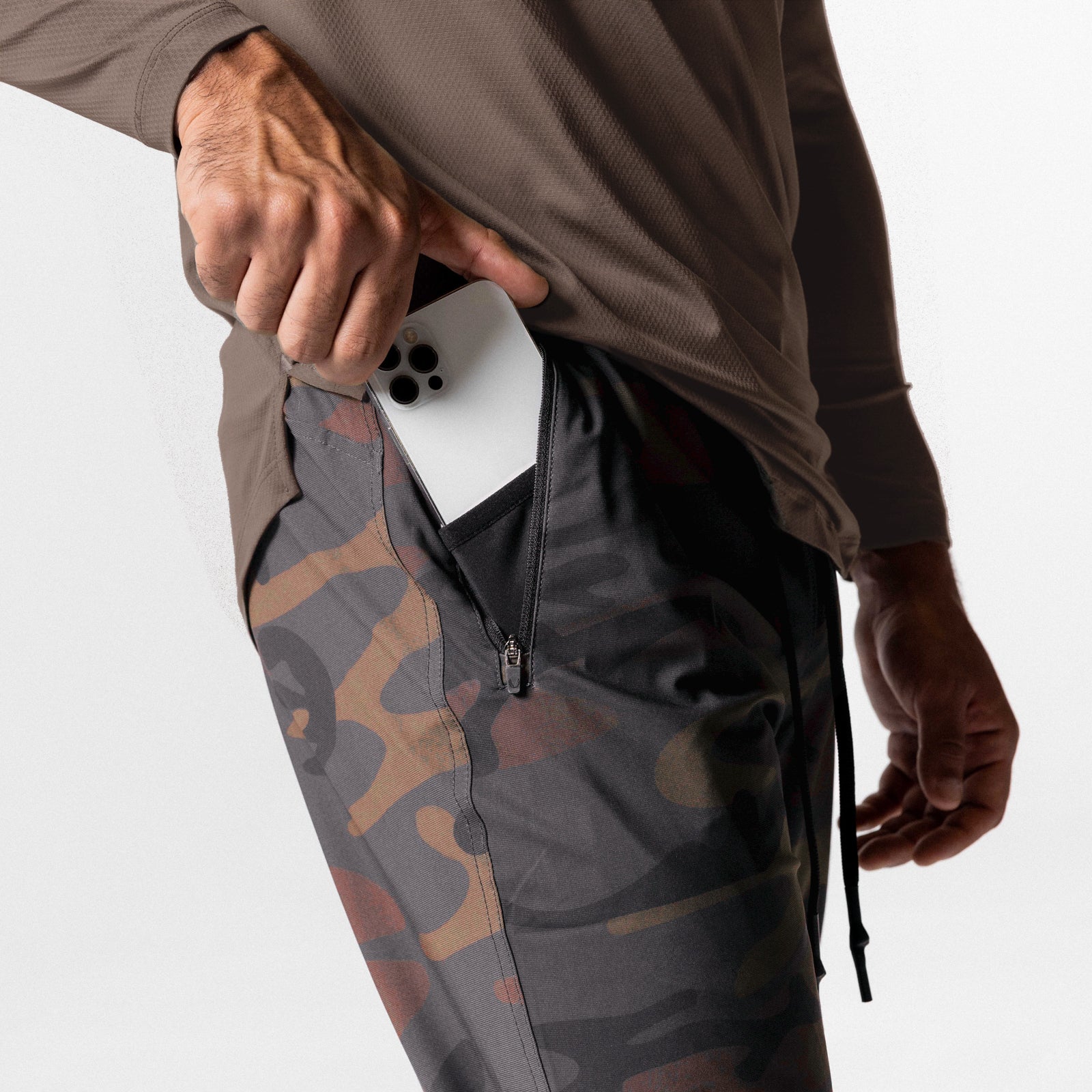 Tetra-Lite High Rib Jogger in rust camo worn by model holding white phone in pocket